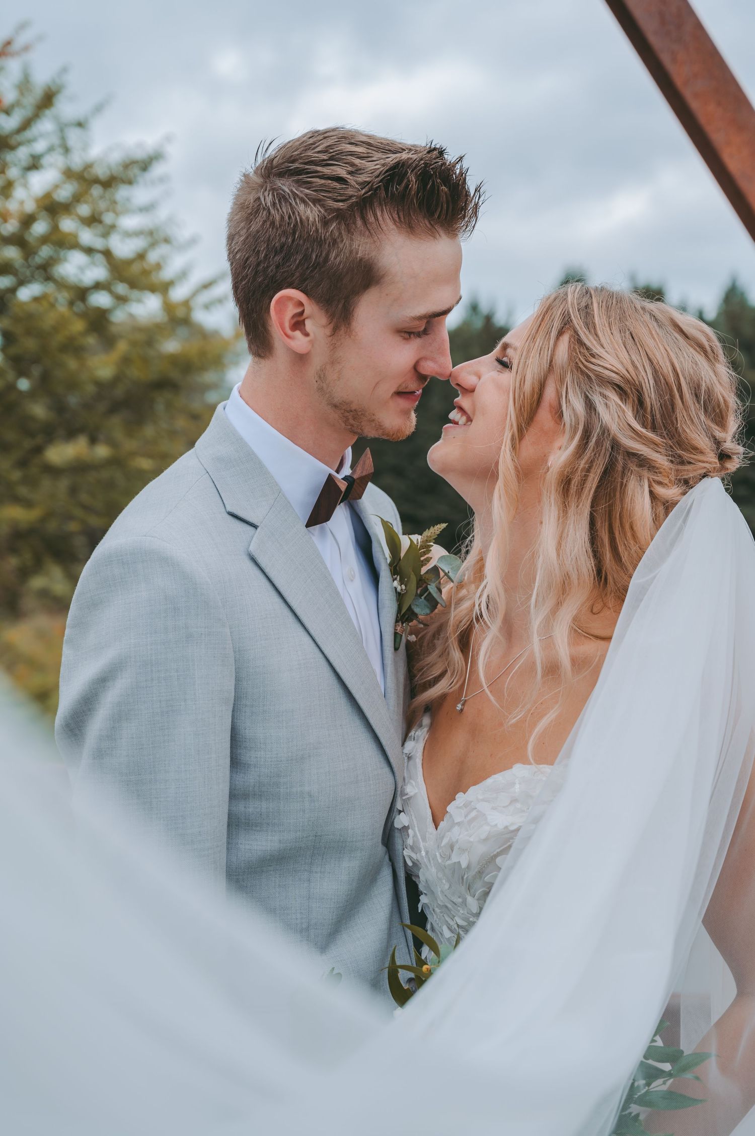 A tender moment between newlyweds captured in an intimate outdoor setting.