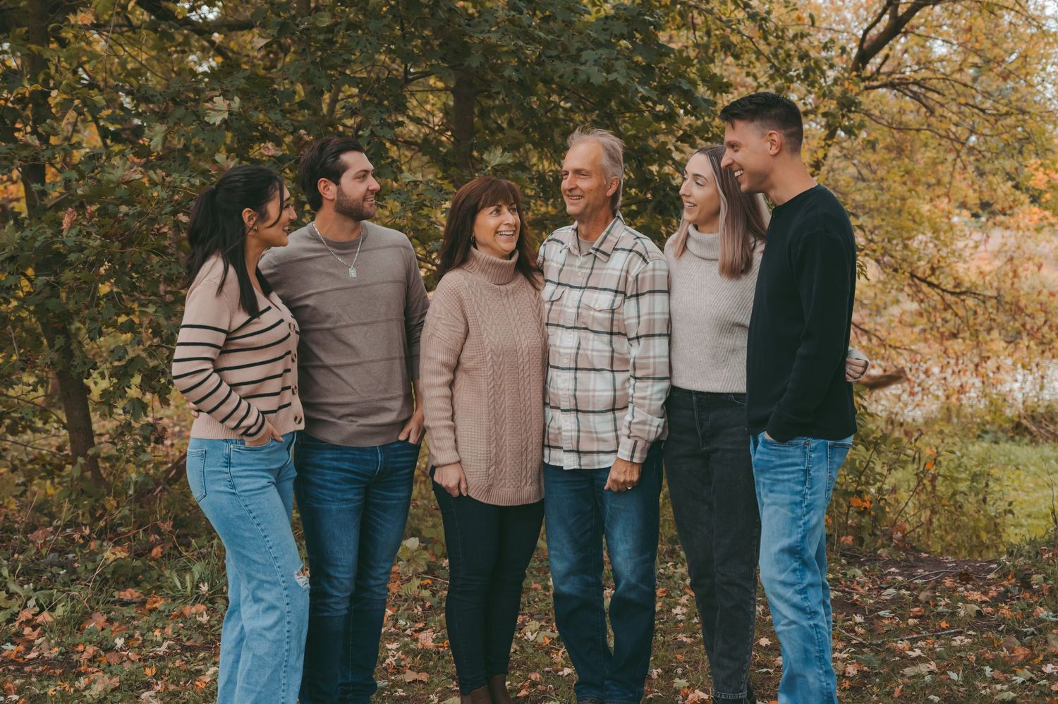 Casual family group portrait taken outdoors during autumn season.