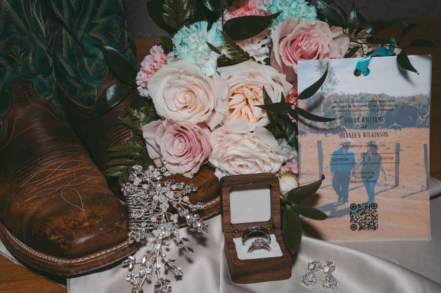 Wedding details including roses, rings, and decorative elements arranged with a vintage leather shoe.