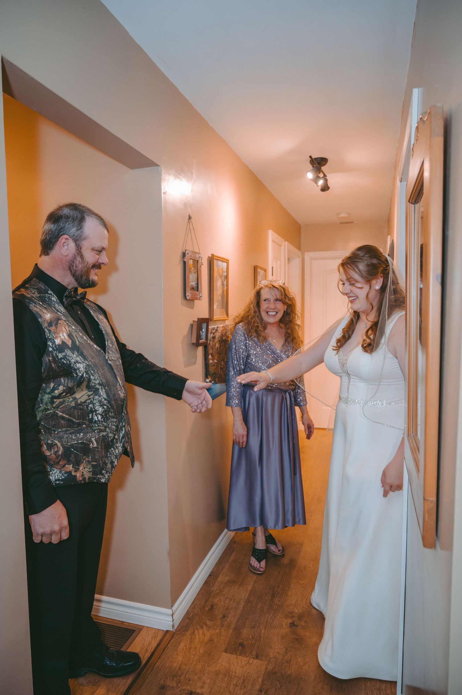 Special moment before wedding ceremony in a hallway with bride in white dress.