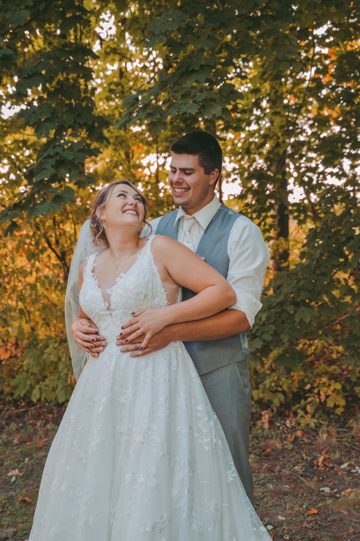 Candid wedding photos showing laughter and joy in autumn setting.