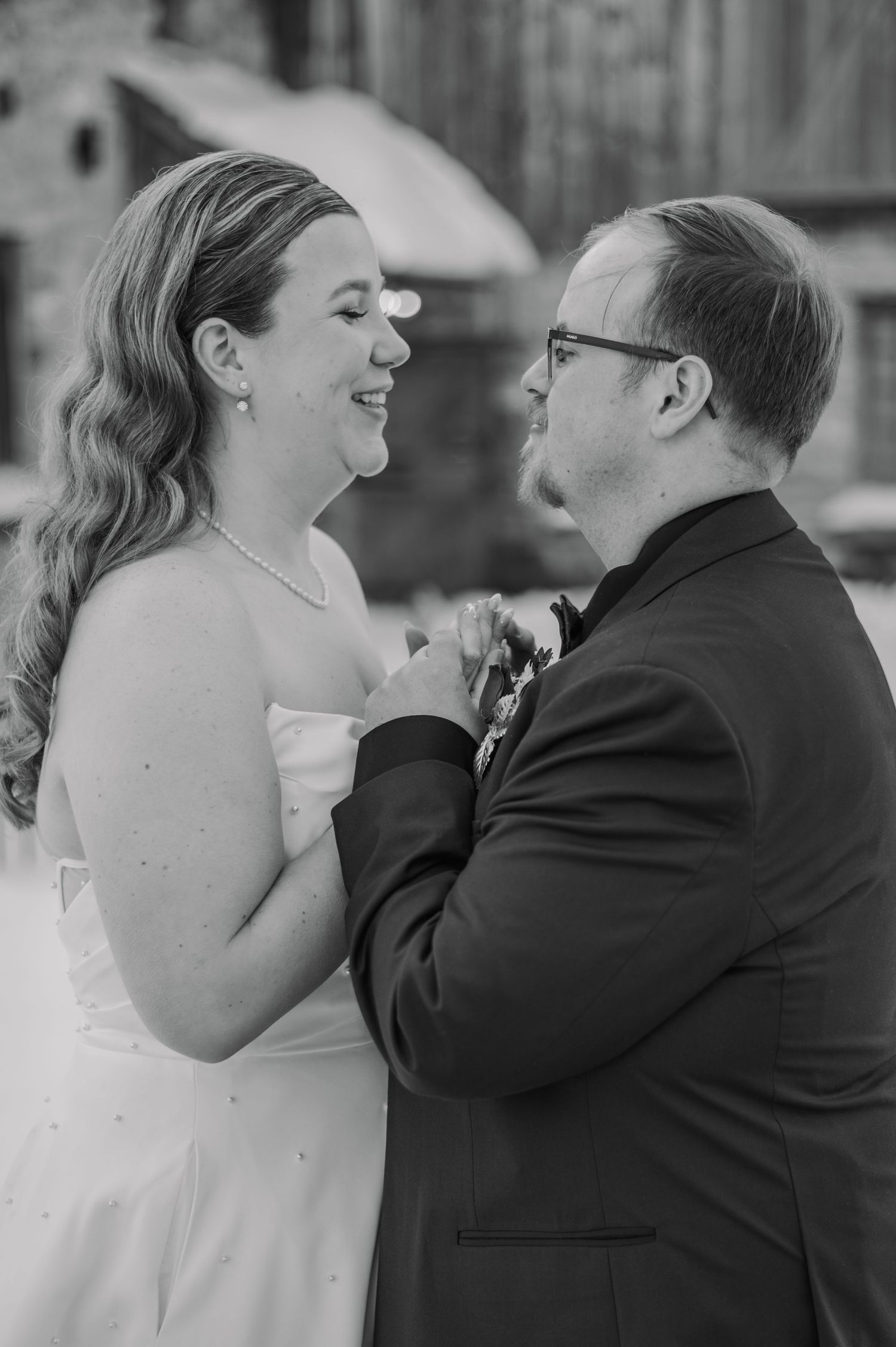 Black and white photo showing a tender emotional moment between a bride and groom during their wedding day.