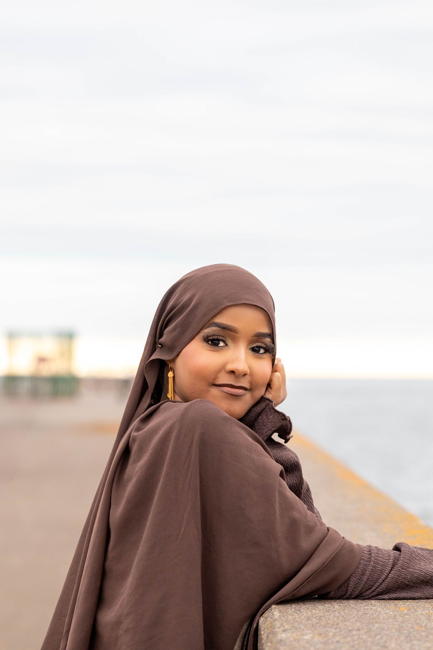 A series of photos showing someone in a brown hijab posing against a blurred outdoor background.