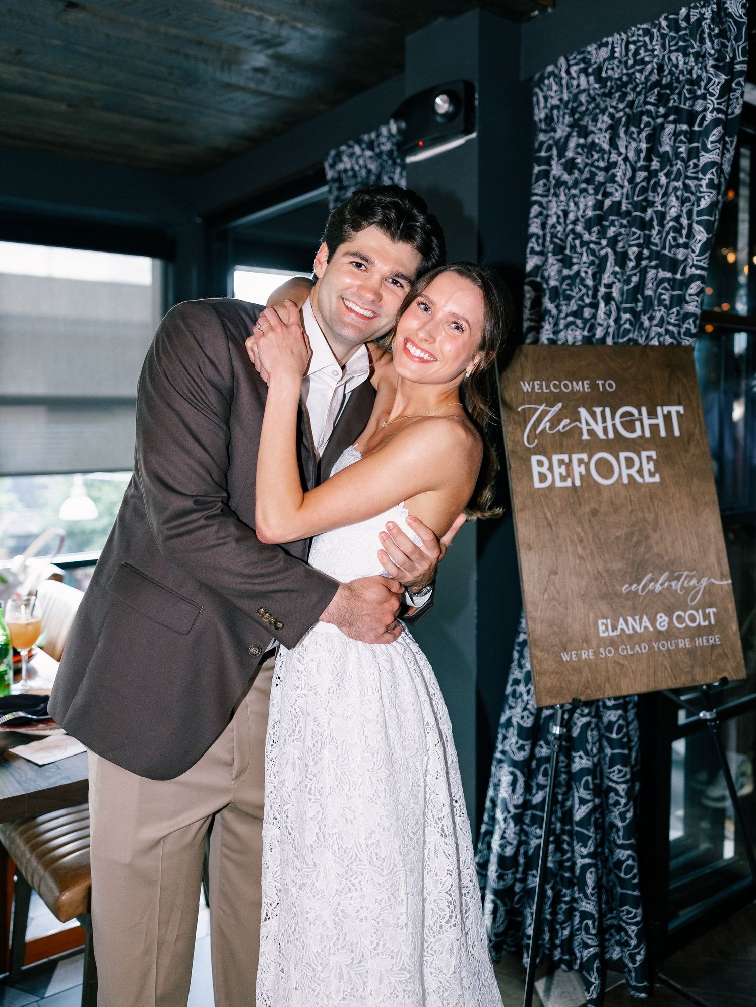 Couple embracing and smiling at The Night Before wedding rehearsal dinner celebration event.