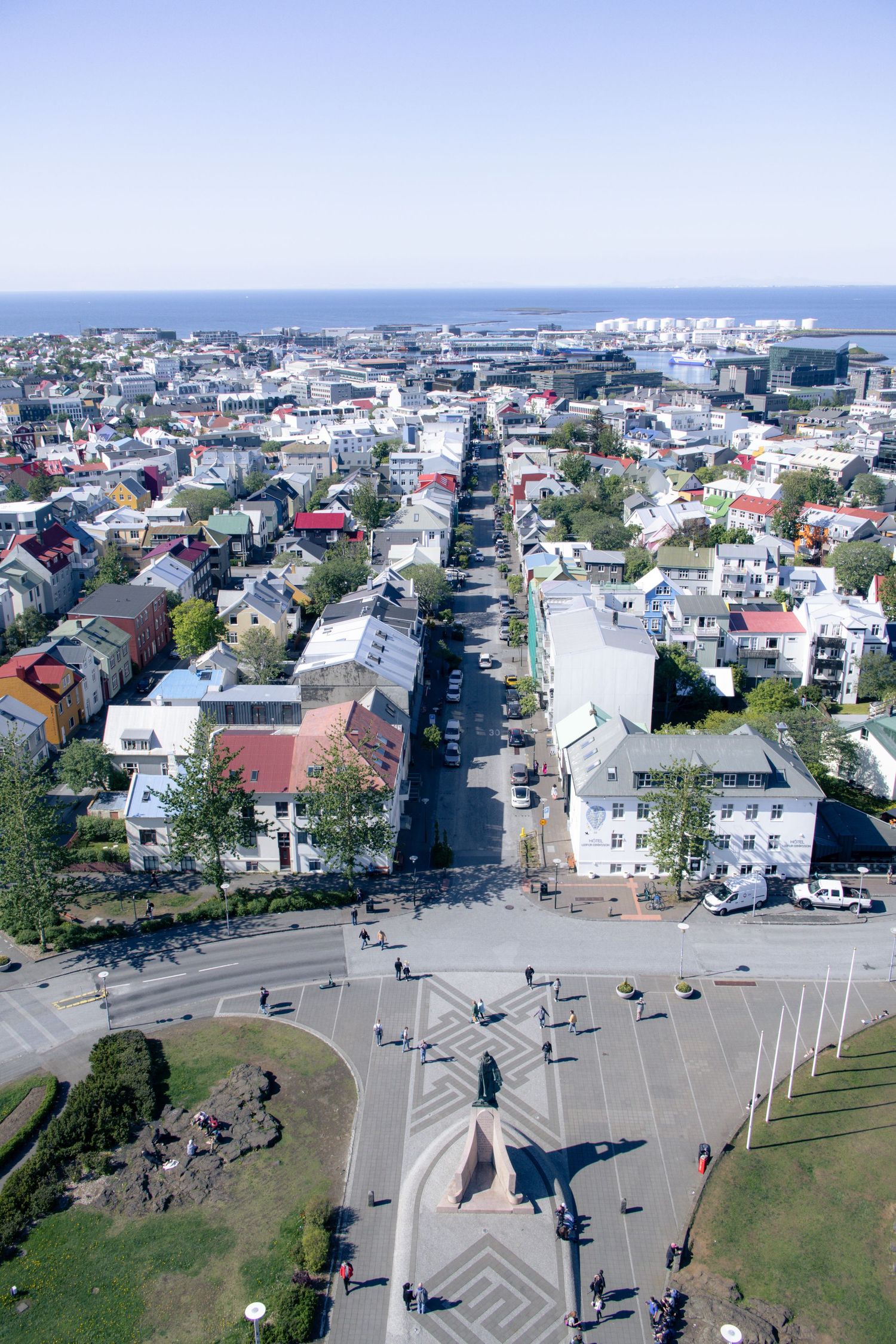 Aerial view of colorful rooftops and city streets in Reykjavík, Iceland stretching toward the sea, ideal for destination travel storytelling