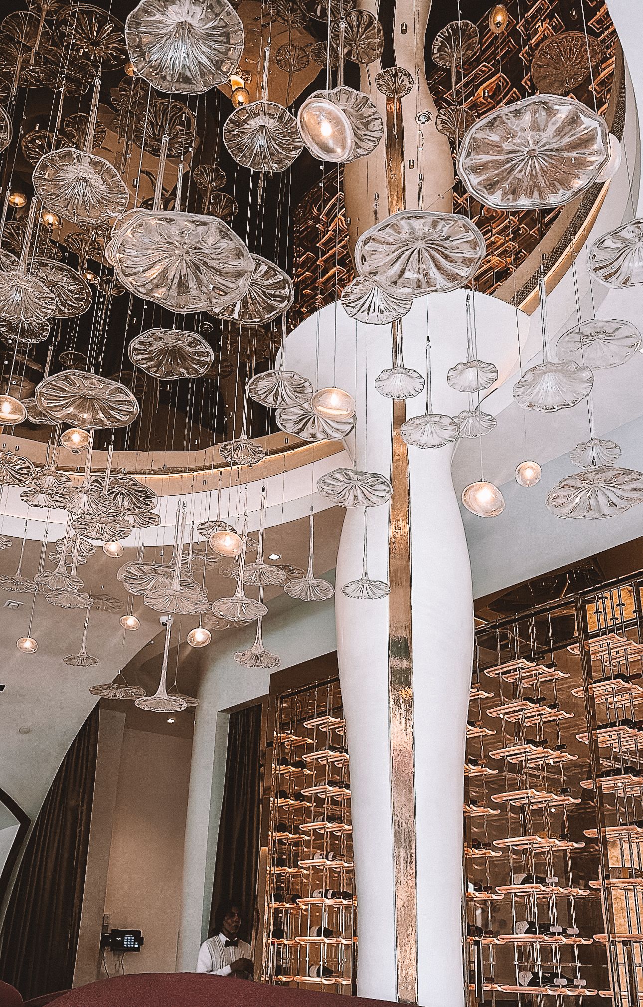 Interior of upscale restaurant with mirrored disco ball ceiling and exposed brick, styled for luxury dining ambiance