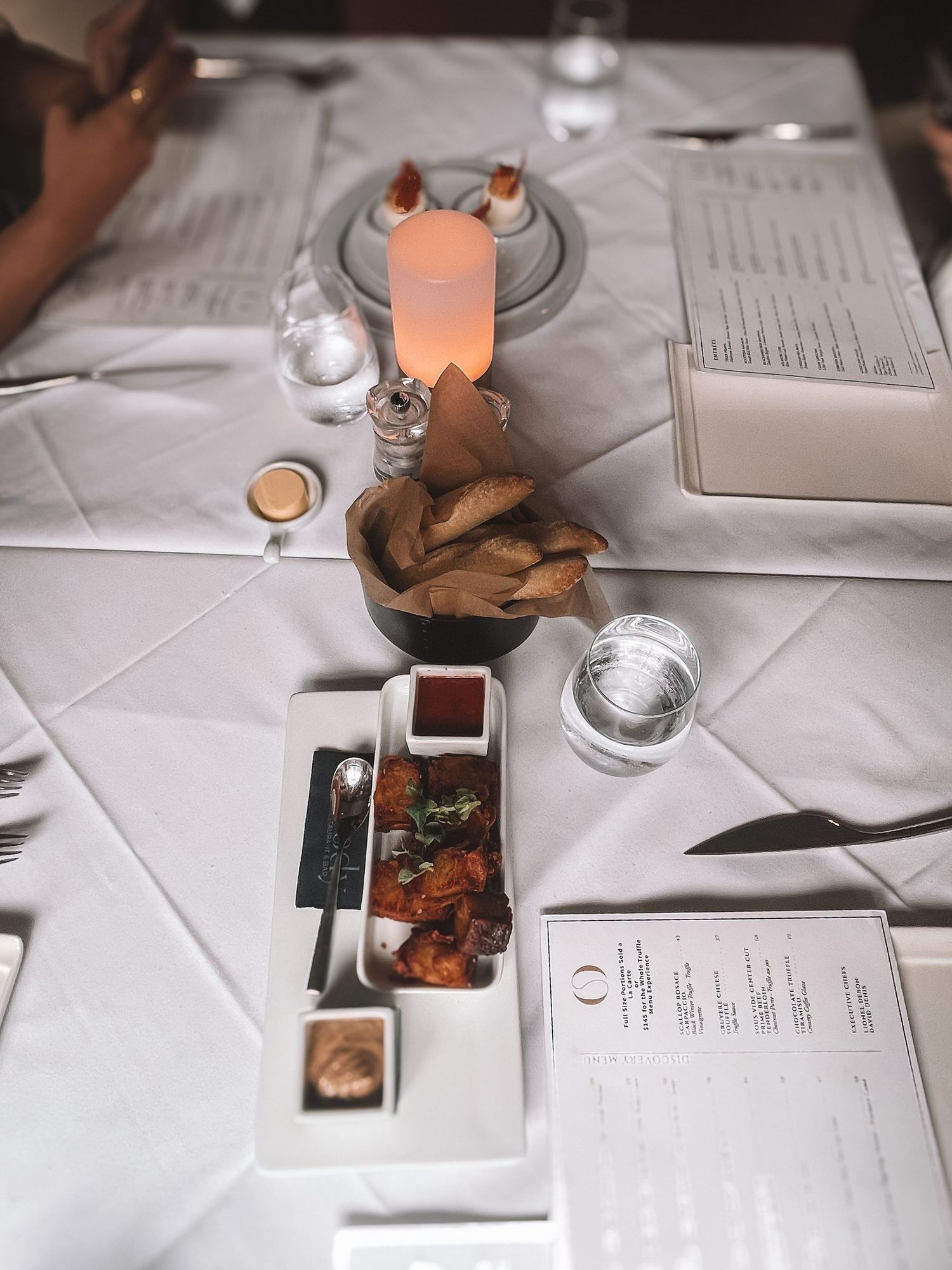 Overhead shot of styled tabletop with coffee, flowers, and creative workspace items