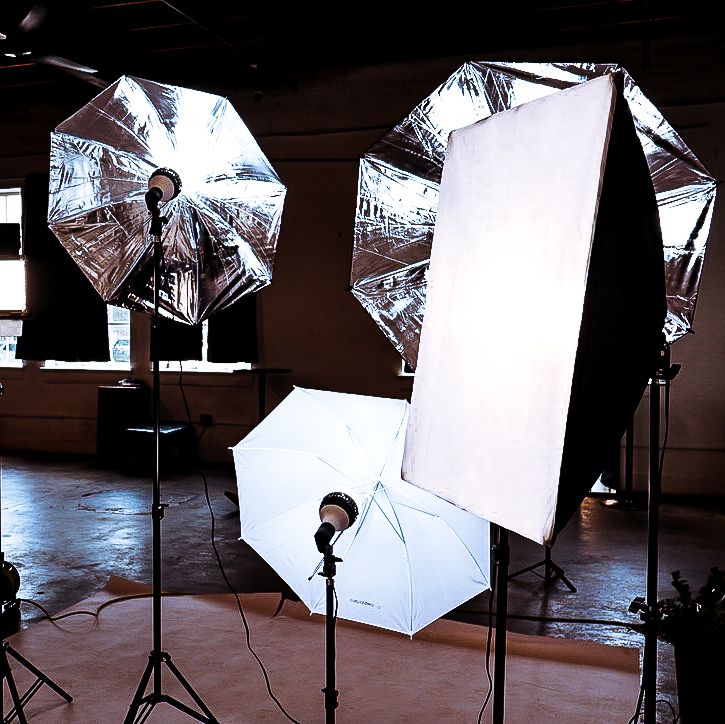 Professional photo studio setup with softbox lights and seamless backdrop, staged for brand or editorial shoot