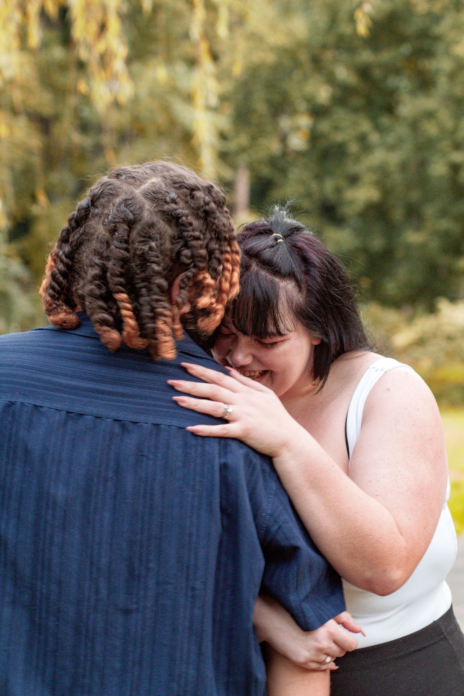 Tender embrace captured during outdoor couples portrait session.