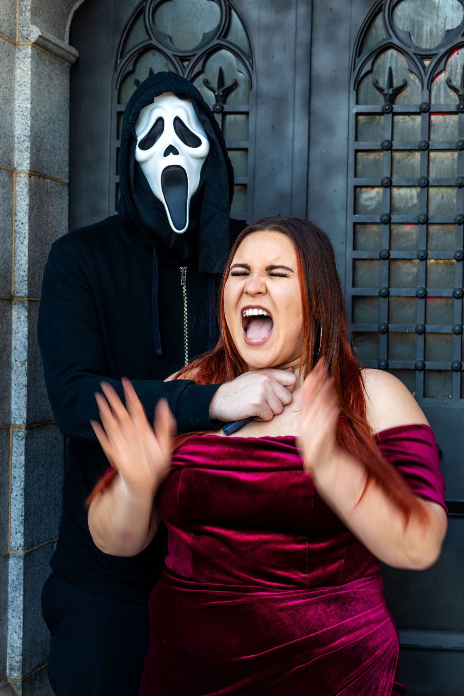 Four sequential photos show someone in burgundy velvet reacting to a person in a white ghost mask making scary gestures.