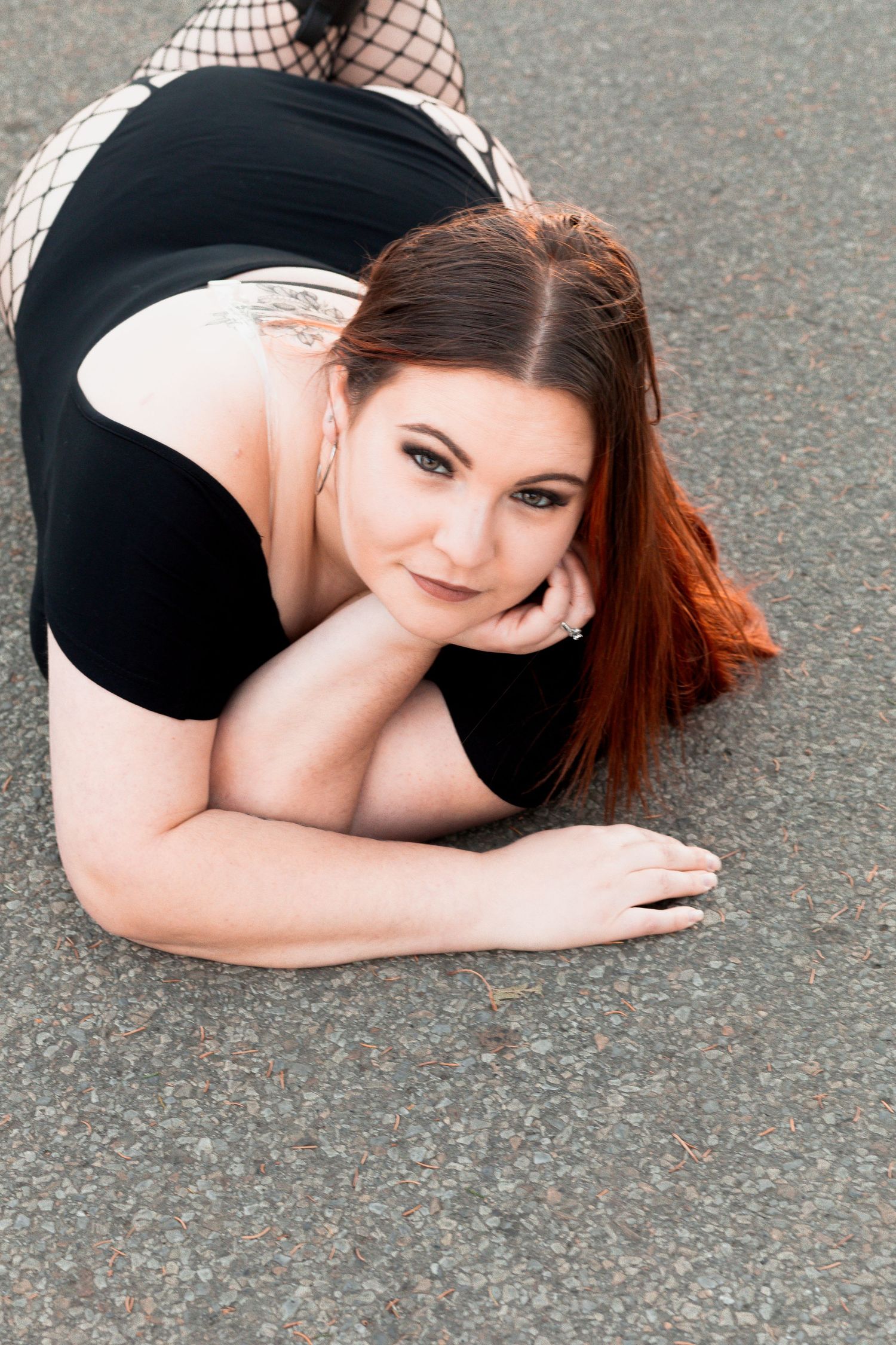 Artistic black and white portrait session showing creative poses on asphalt.