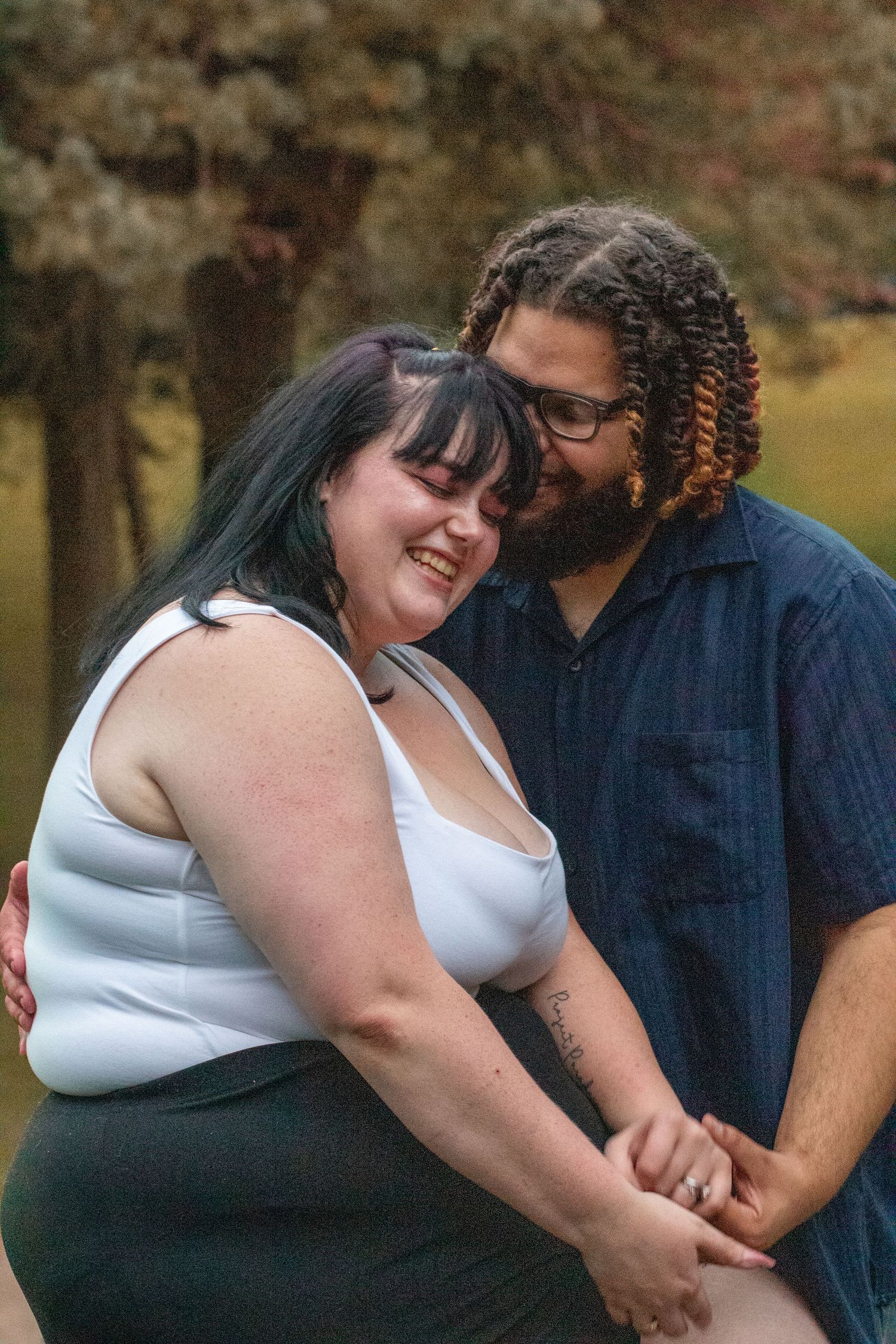 Intimate couples photoshoot outdoors capturing candid loving moments.