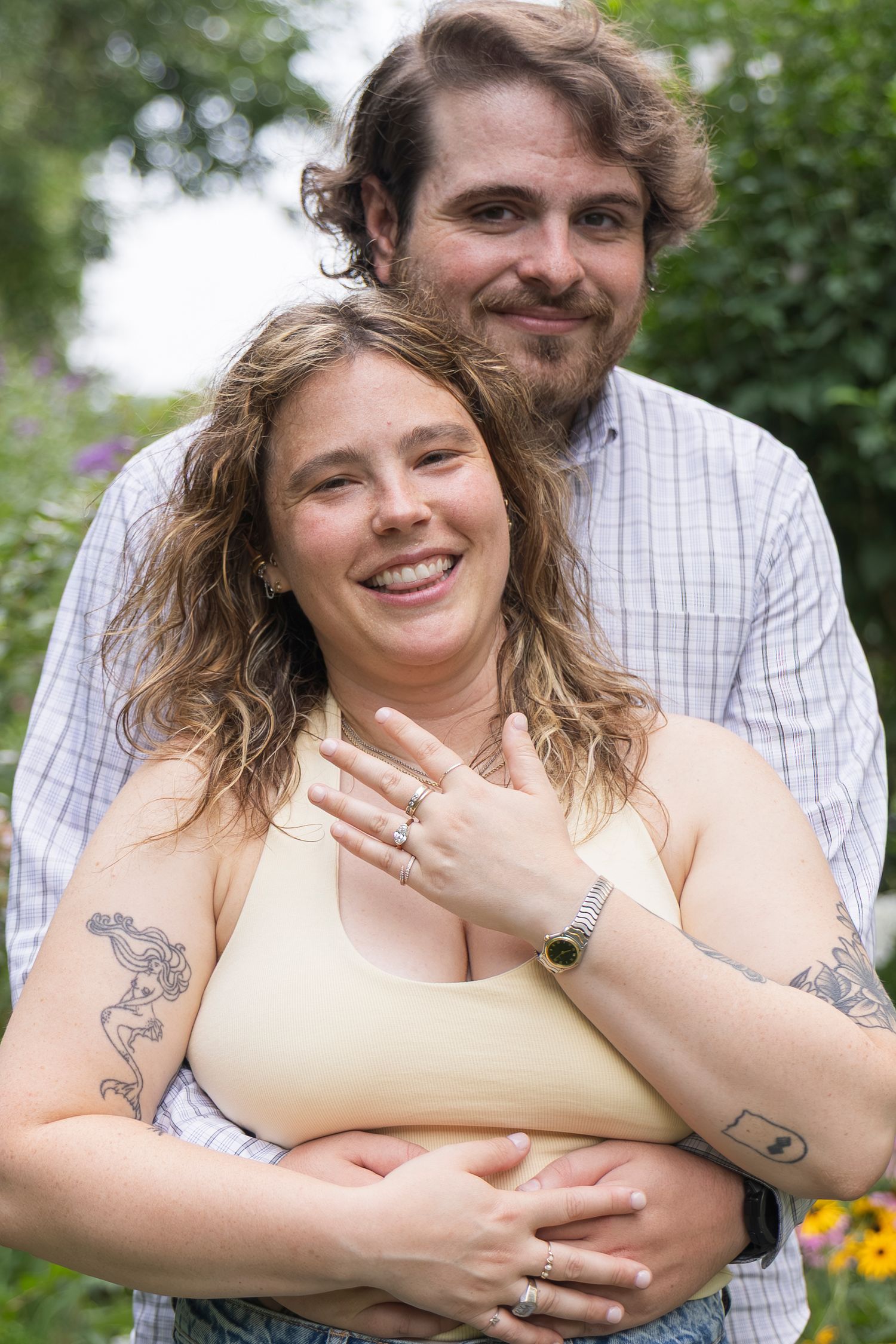 Candid moment of couple laughing together after proposal – NYC surprise engagement session by Laura Mahl