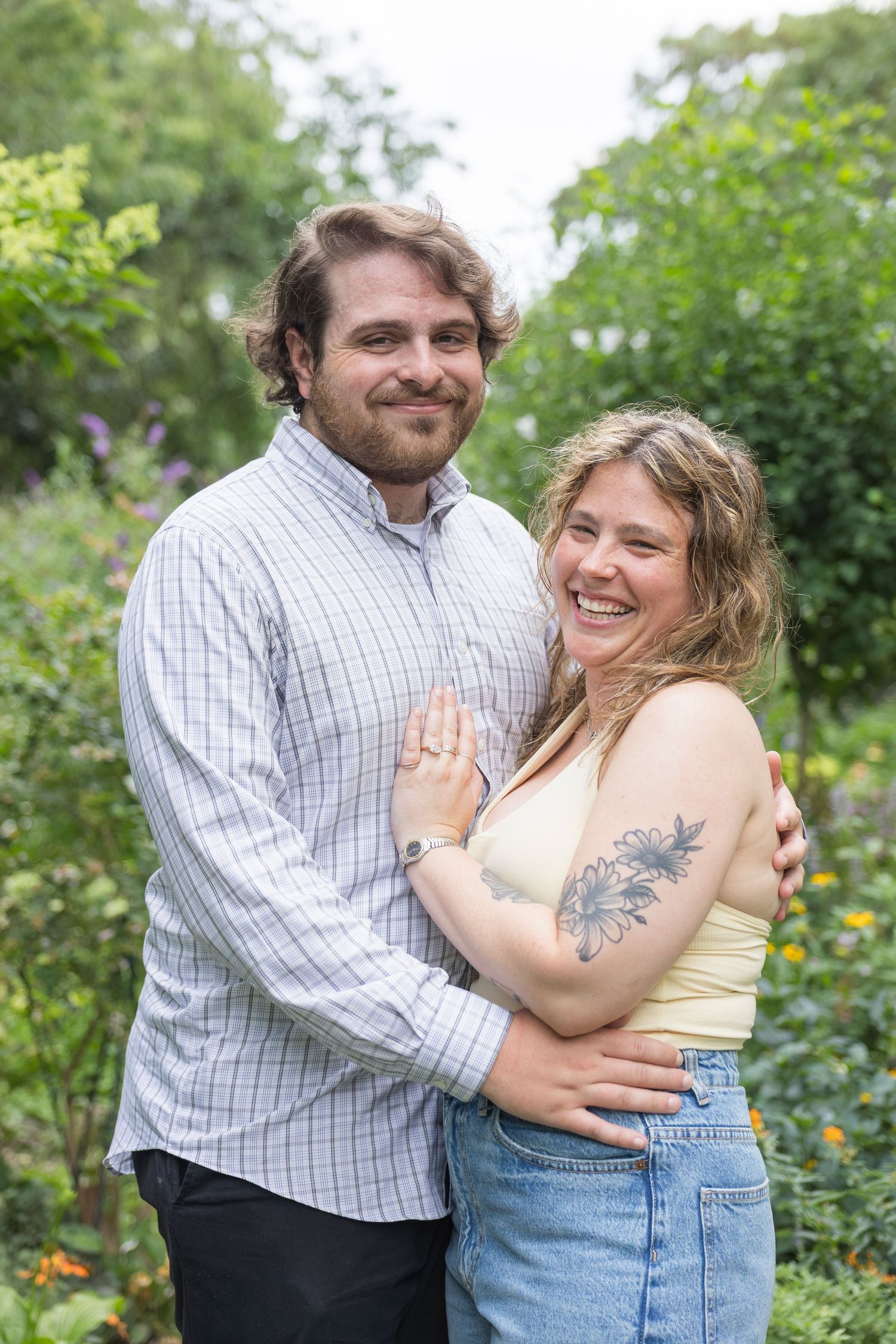 Candid moment of couple laughing together after proposal – NYC surprise engagement session by Laura Mahl