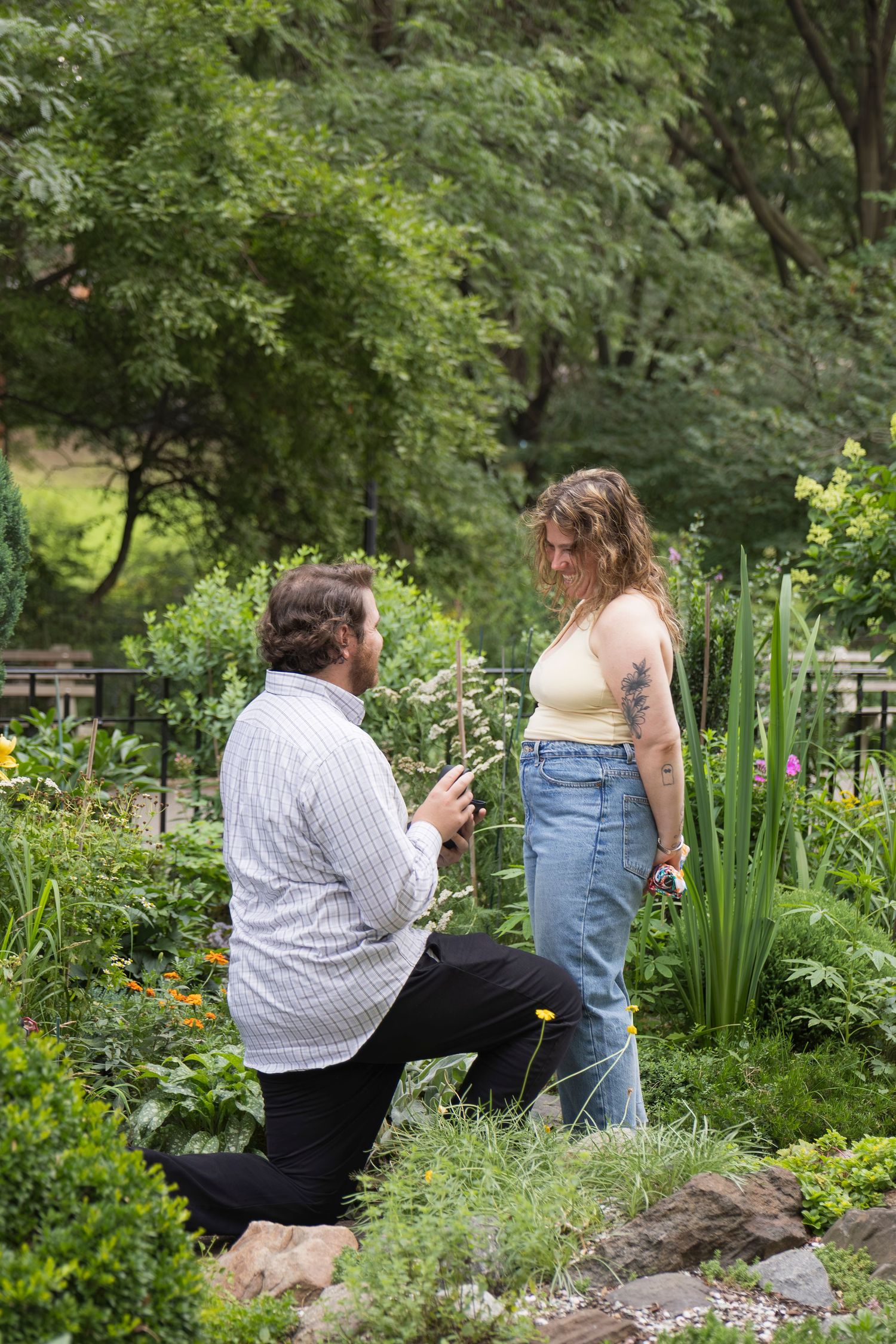 Candid moment of couple laughing together after proposal – NYC surprise engagement session by Laura Mahl