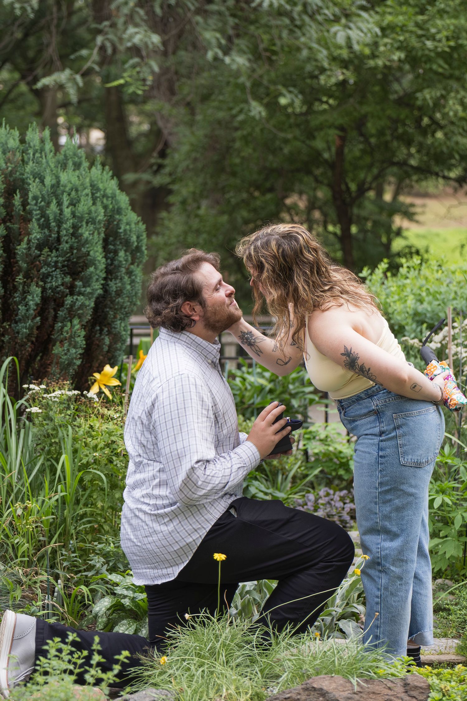 Candid moment of couple laughing together after proposal – NYC surprise engagement session by Laura Mahl