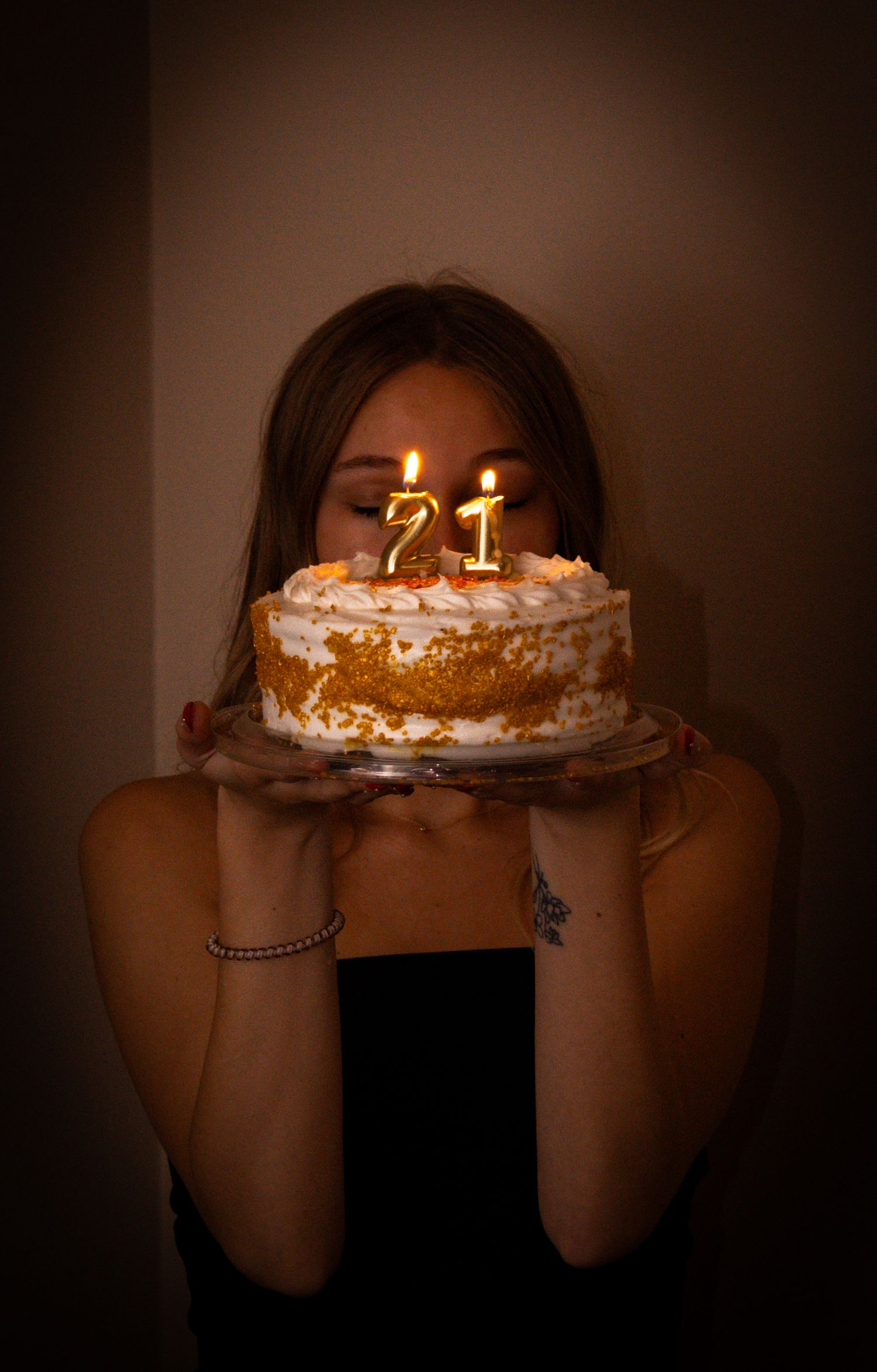 Woman celebrating her twenty-first birthday with a cake.