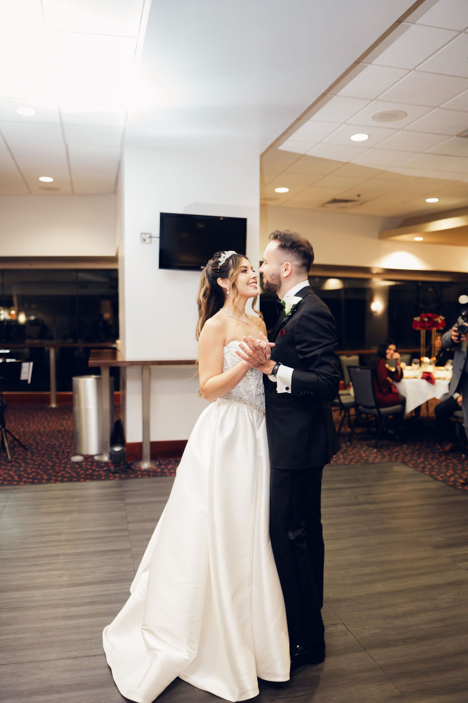 Bride and groom share romantic first dance at elegant wedding reception venue.