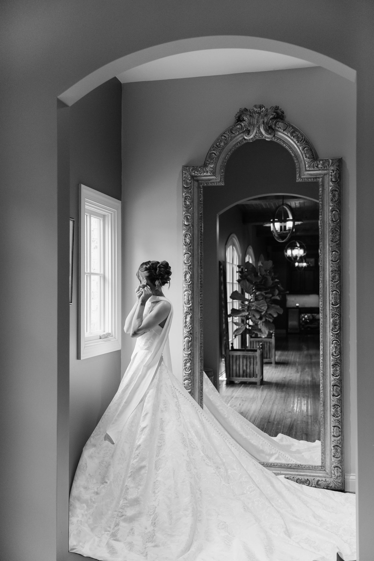 A sequence of elegant bridal photos in black and white showing a wedding dress with flowing train in an ornate mirror.