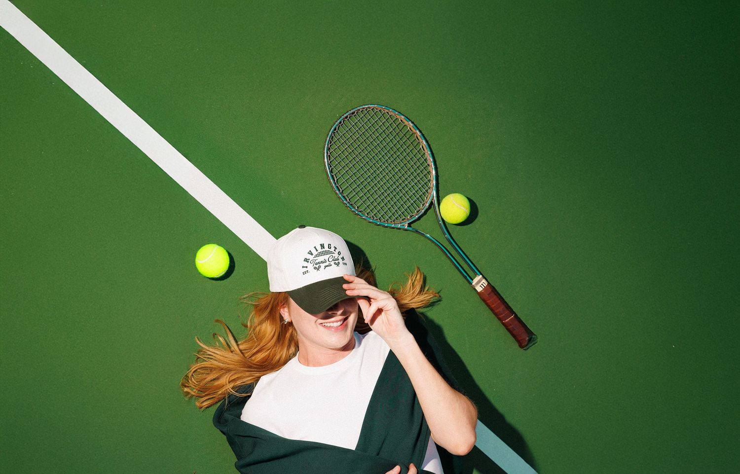 Tennis player serving a tennis ball with a green background showing motion blur effect across multiple frames.