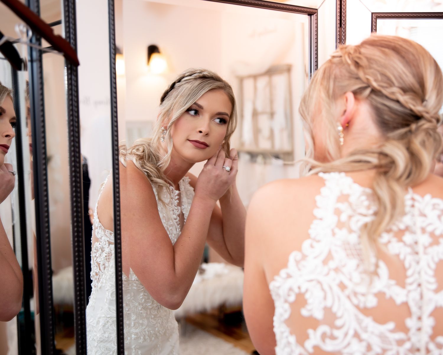 Close-up shots of a bride in a delicate lace dress through window frames.