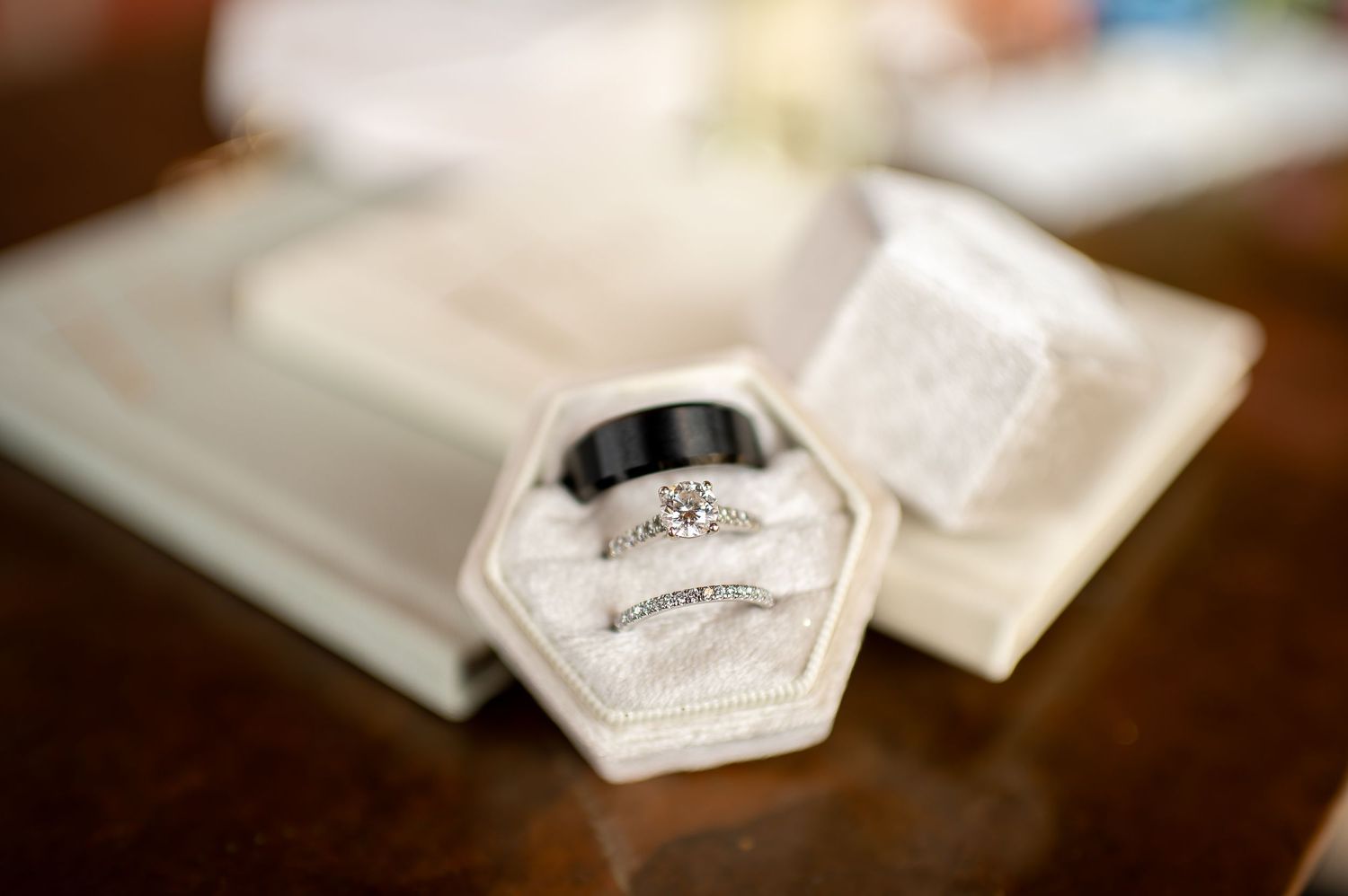 Diamond engagement ring nestled in a hexagonal white ring box.