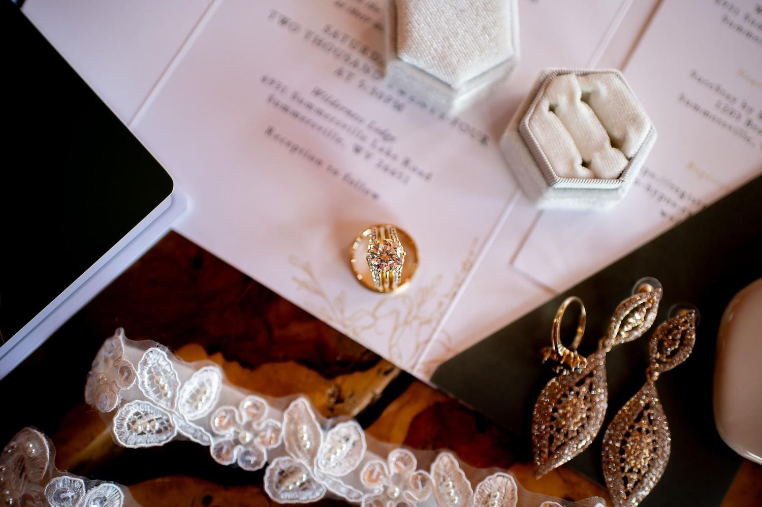 Close-up of wedding accessories including a lace garter, jewelry, and decorative elements.