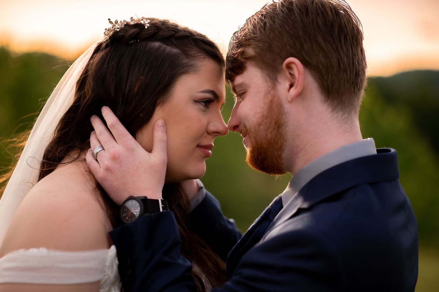 A romantic sunset portrait of newlyweds sharing an intimate moment.