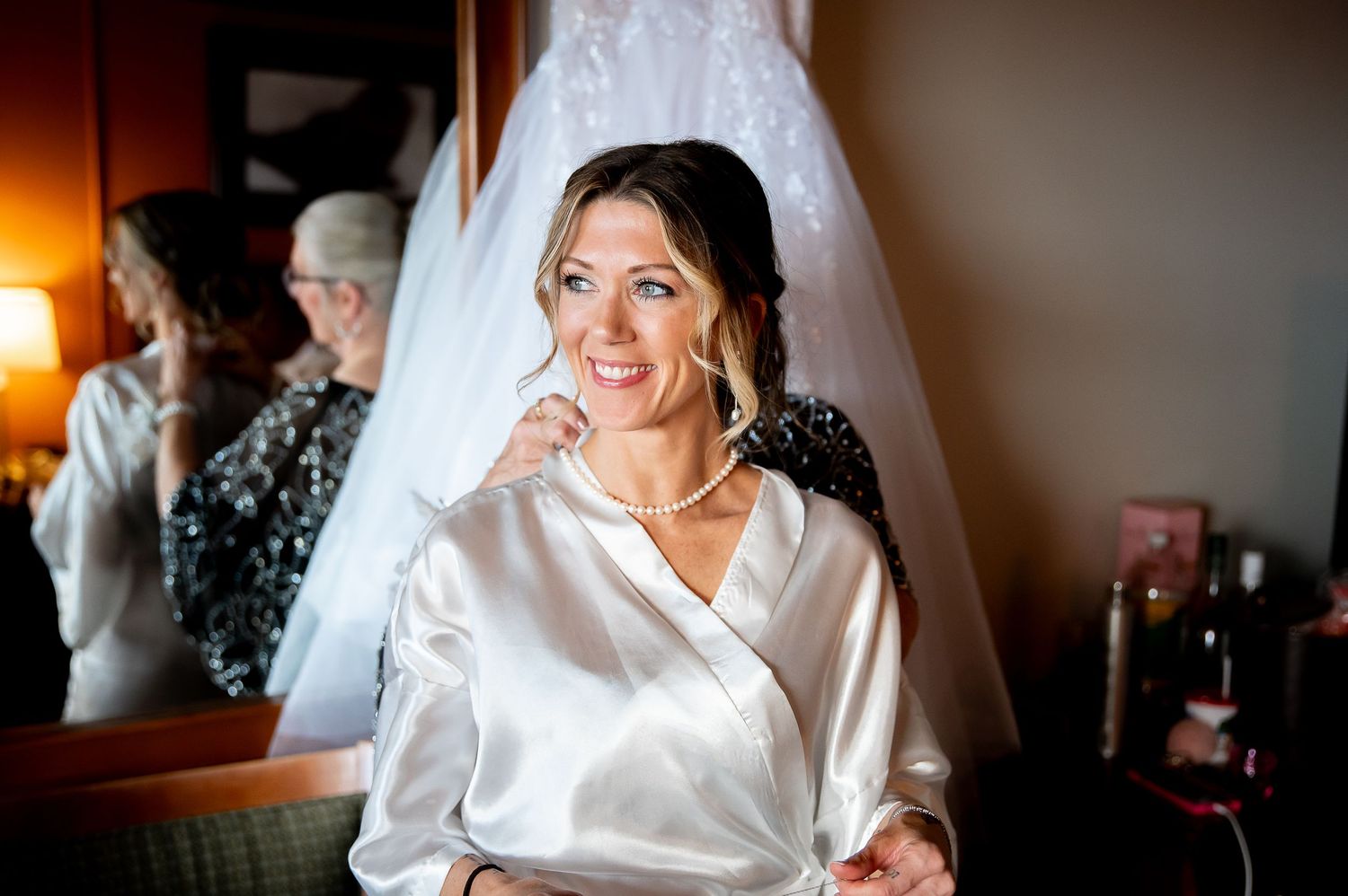 Wedding preparation moments captured in warm, intimate lighting.