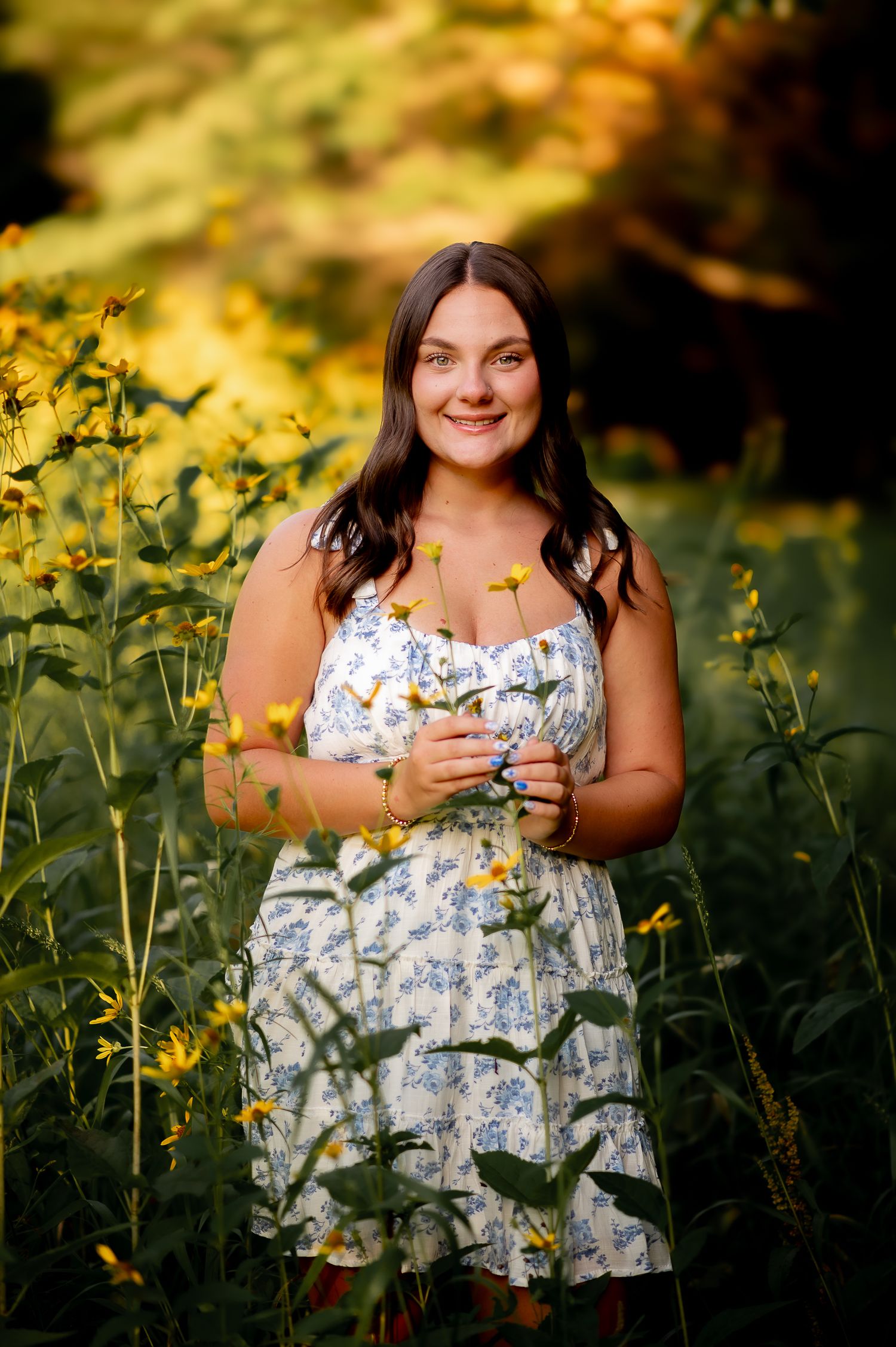 A series of outdoor portrait shots showing someone in a floral dress surrounded by blooming yellow wildflowers at sunset.