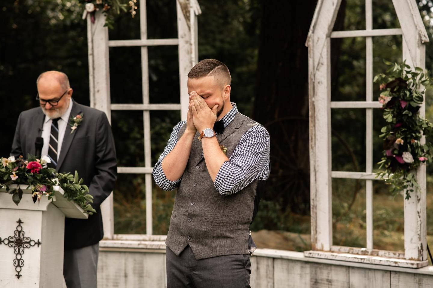 An emotional wedding moment captured between loved ones at an elegant outdoor venue.