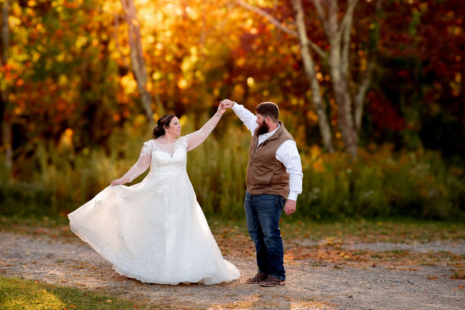 Golden autumn sunlight illuminates a romantic outdoor wedding photoshoot.
