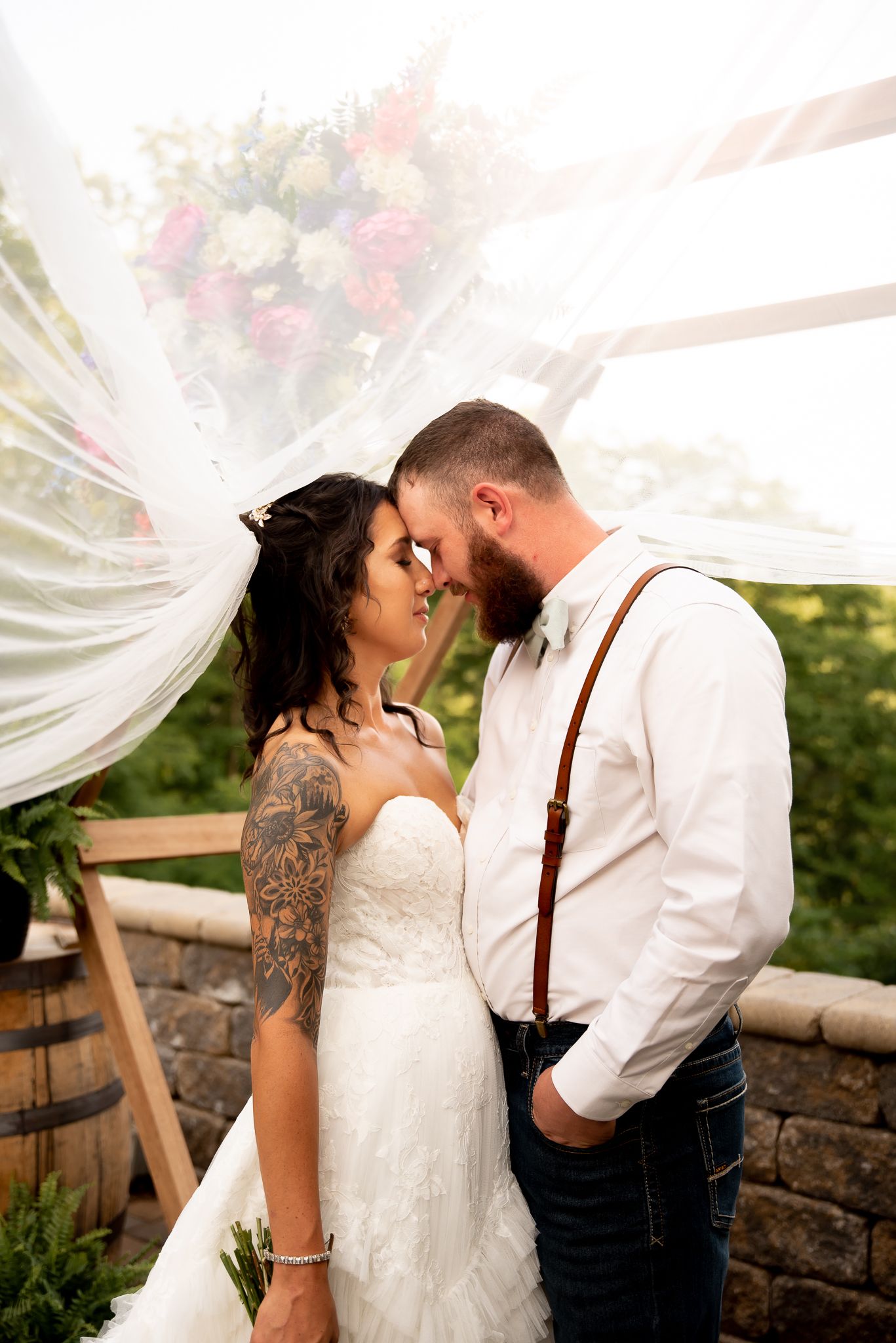 A couple shares an intimate moment during their outdoor wedding ceremony.