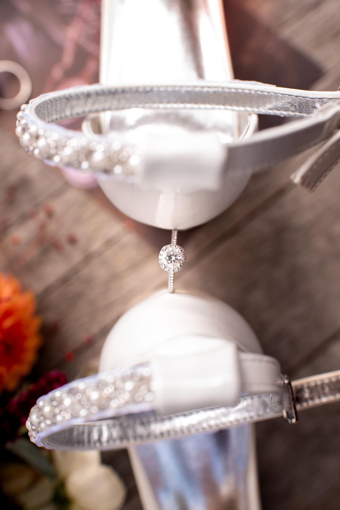 A close-up of wedding ring displays with pearl details and crystal embellishments.