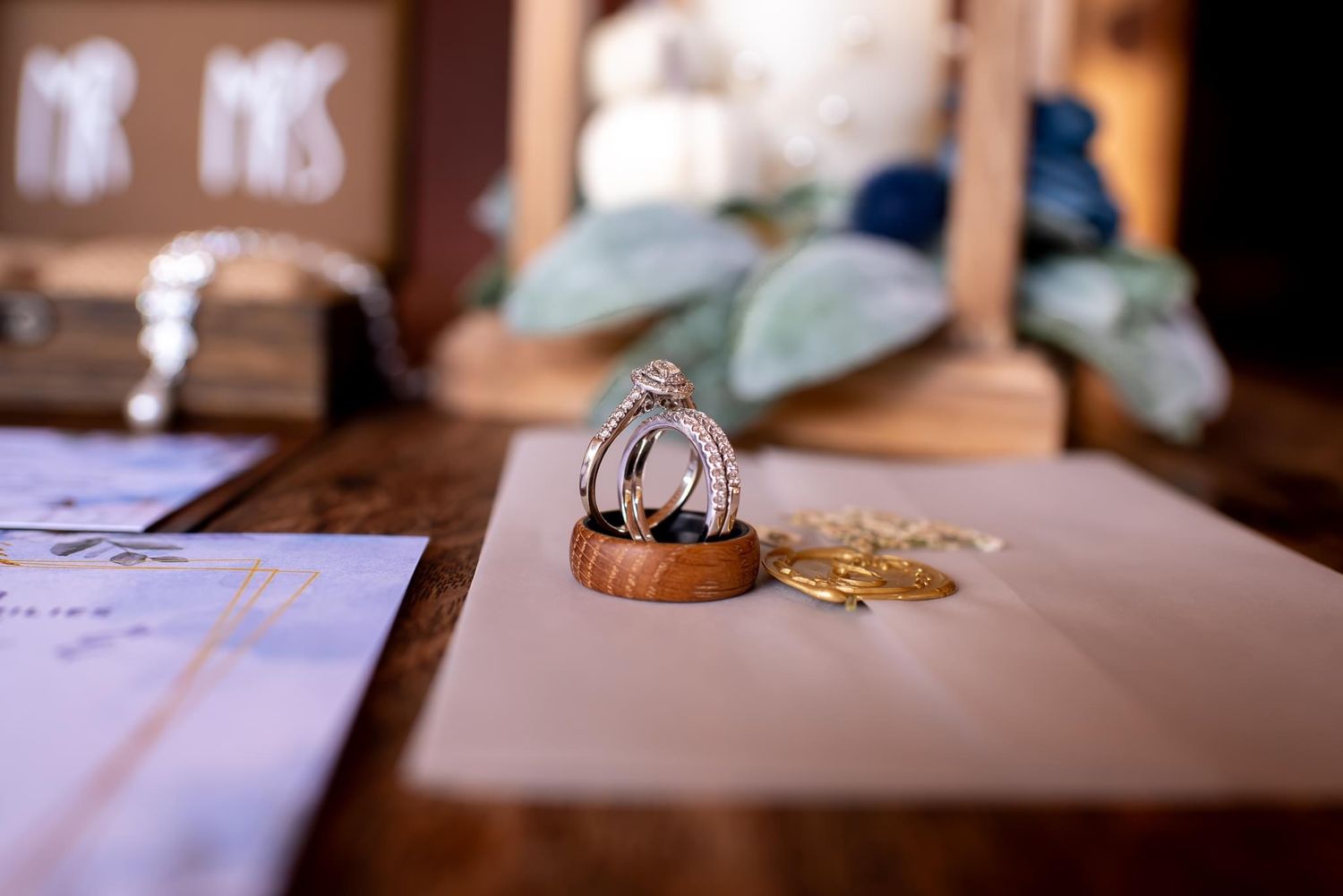 Wedding reception details with blurred table settings and decor in warm lighting.