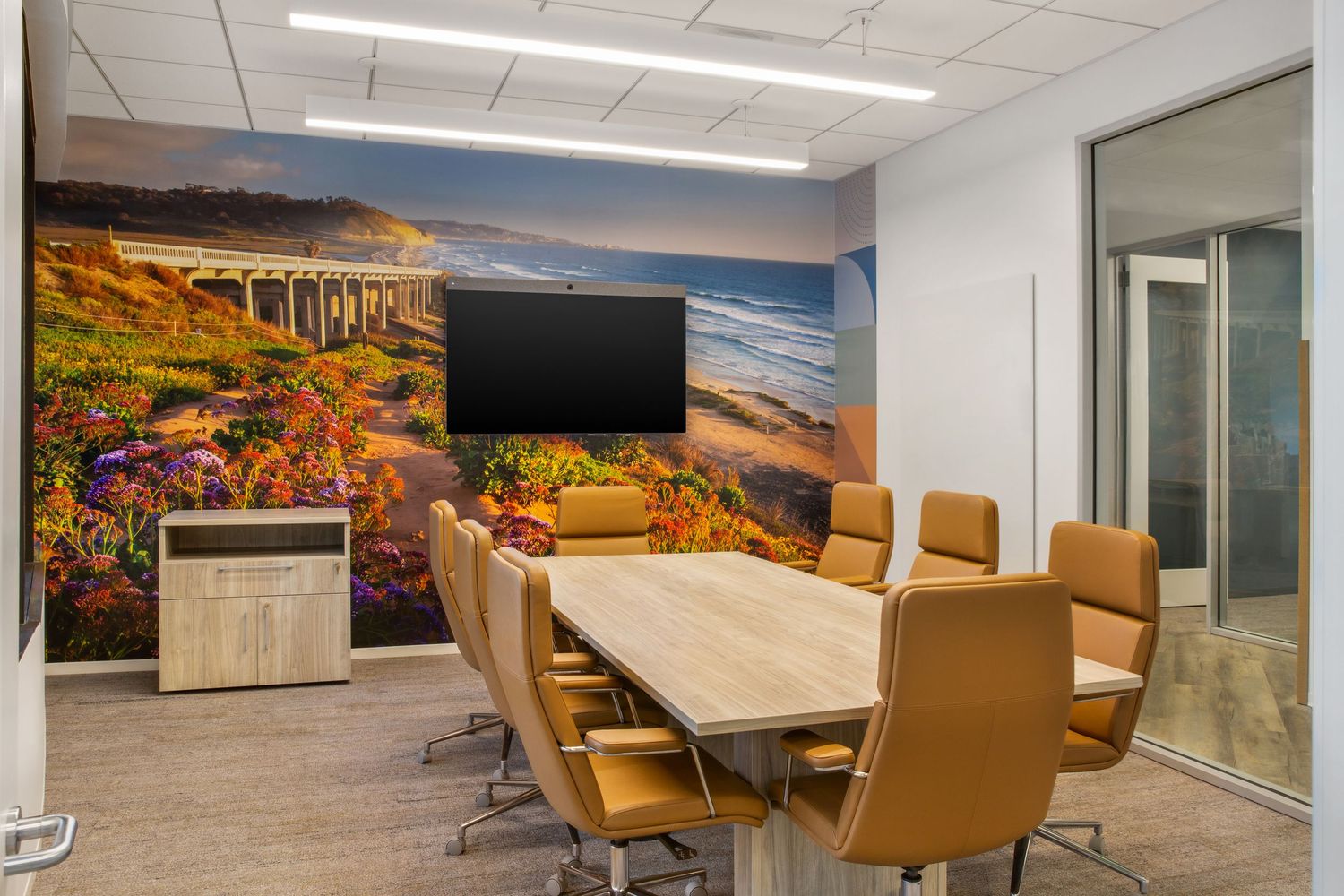 Conference room installation at National Funding’s La Jolla headquarters featuring an art wall inspired by La Jolla Shores. The flowing desi