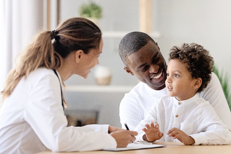 Neuropsychologist speaking with adolescent patient in a clinical setting – compassionate care at Coastal Neuro Group