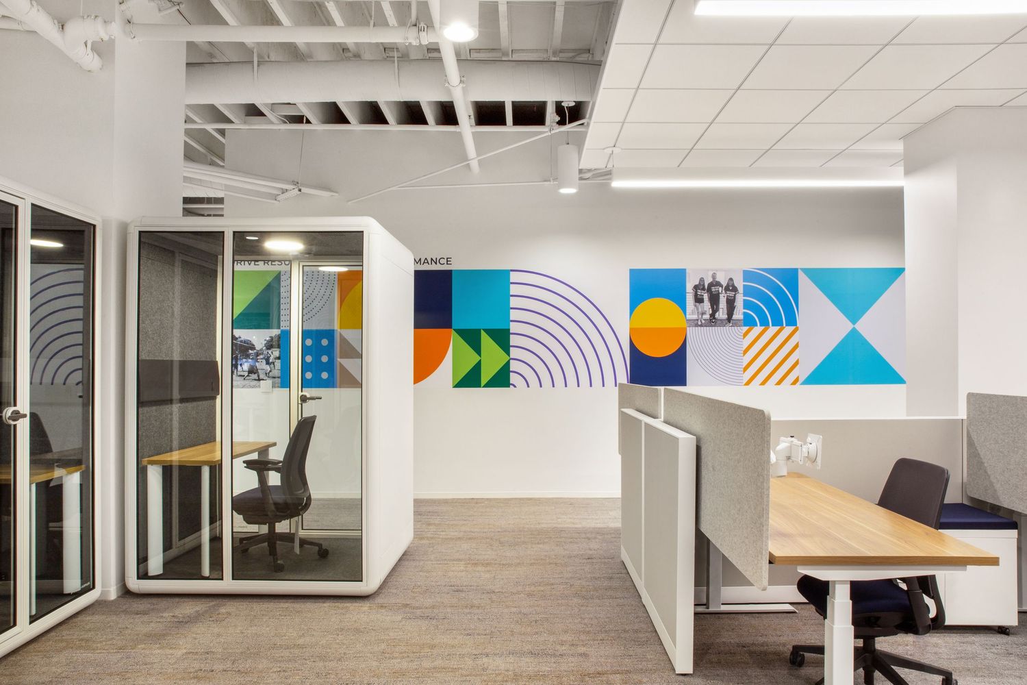 La Jolla Collaboration Space Design Modern workspace with custom art wall and tapestry ribbon graphics expressing National Funding’s values