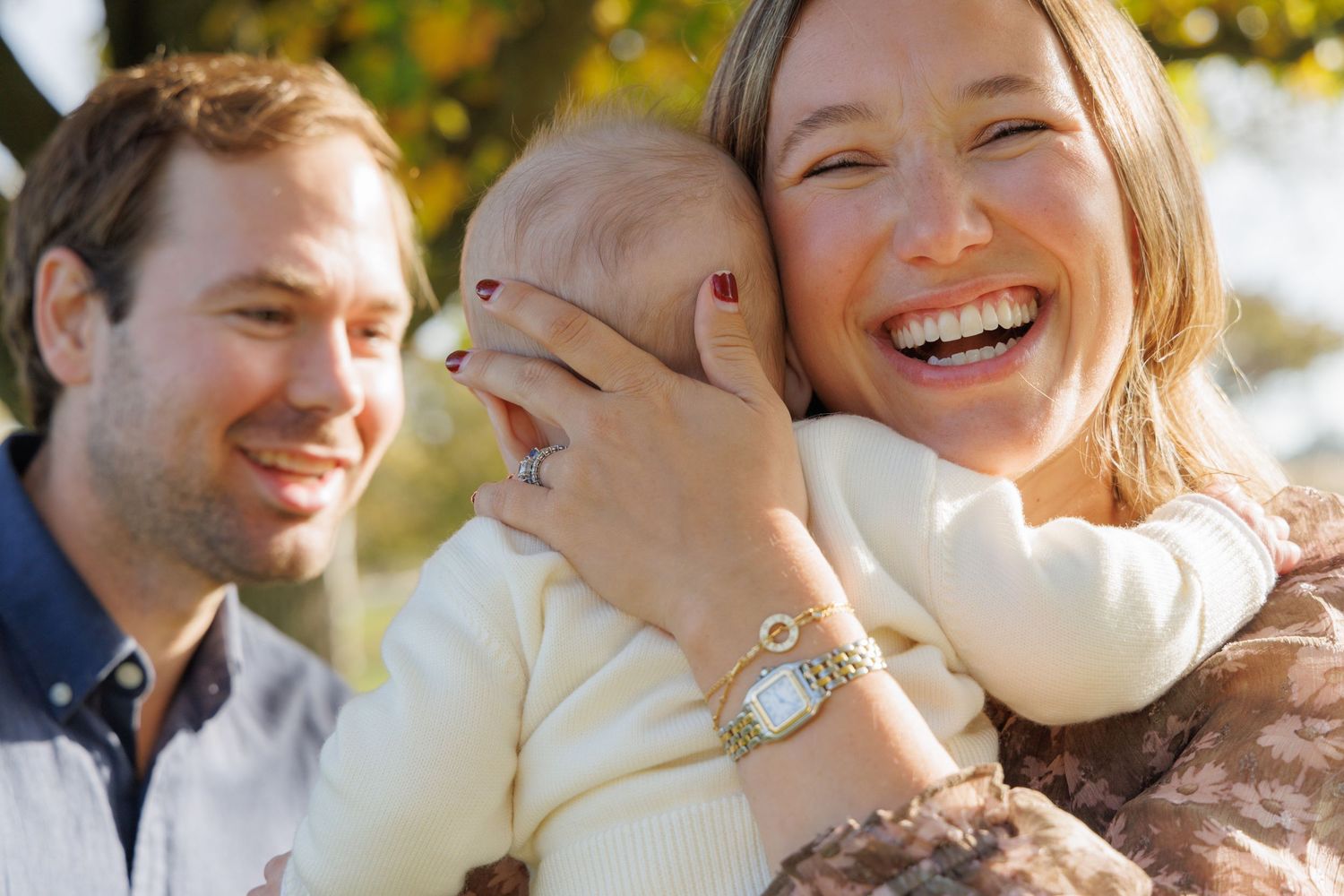 Candid romantic moment between couple sharing laughter outdoors.