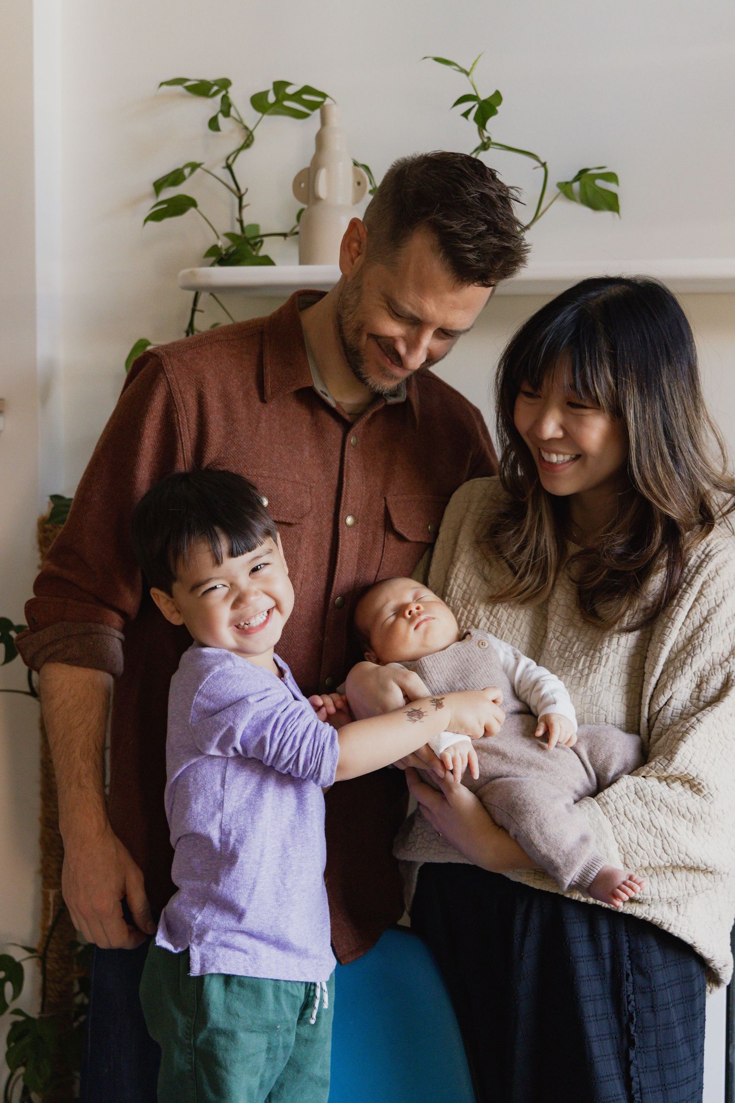 Candid family moments captured in a bright indoor setting with houseplants.
