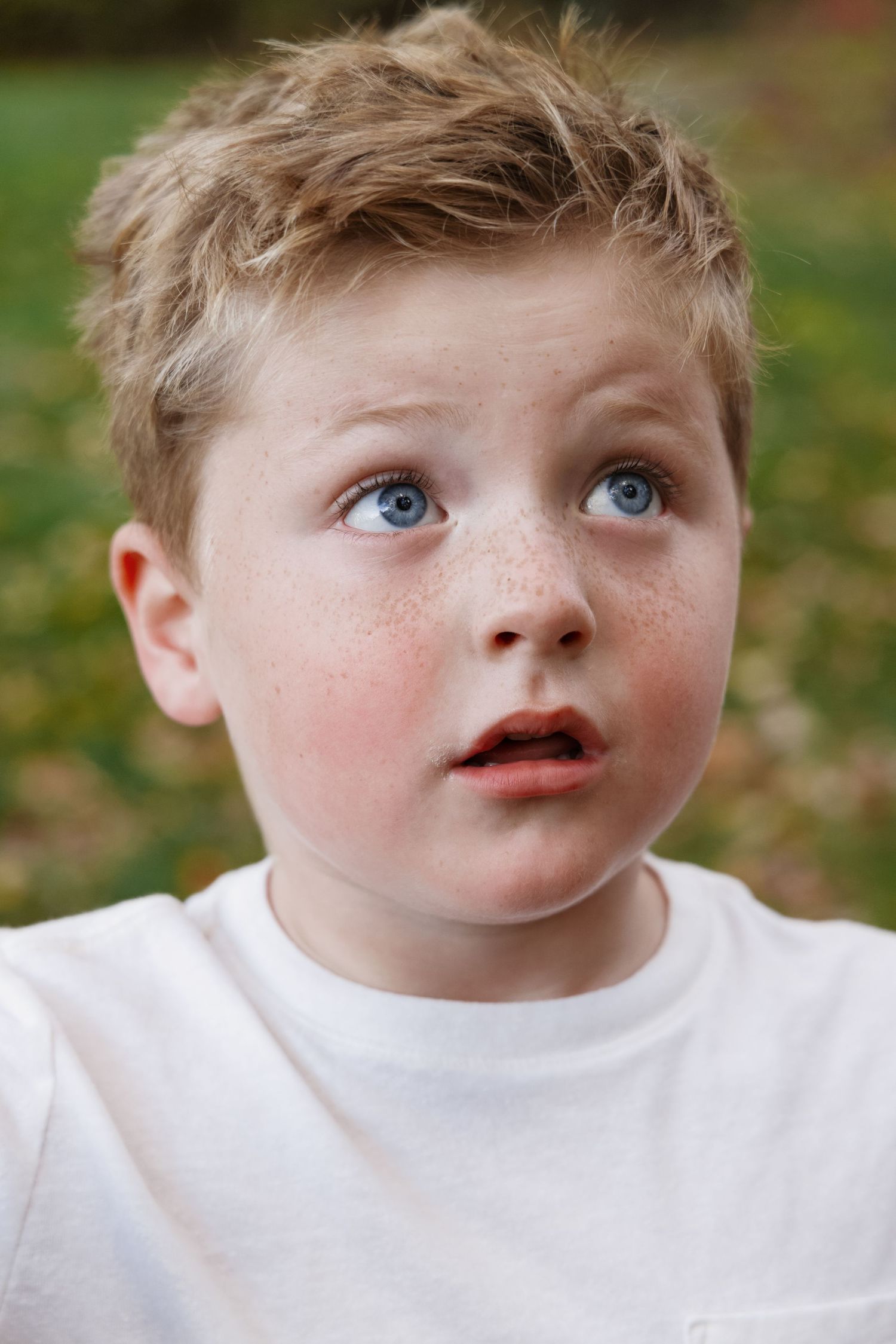 Close-up portrait series showing freckled face with gentle expressions.