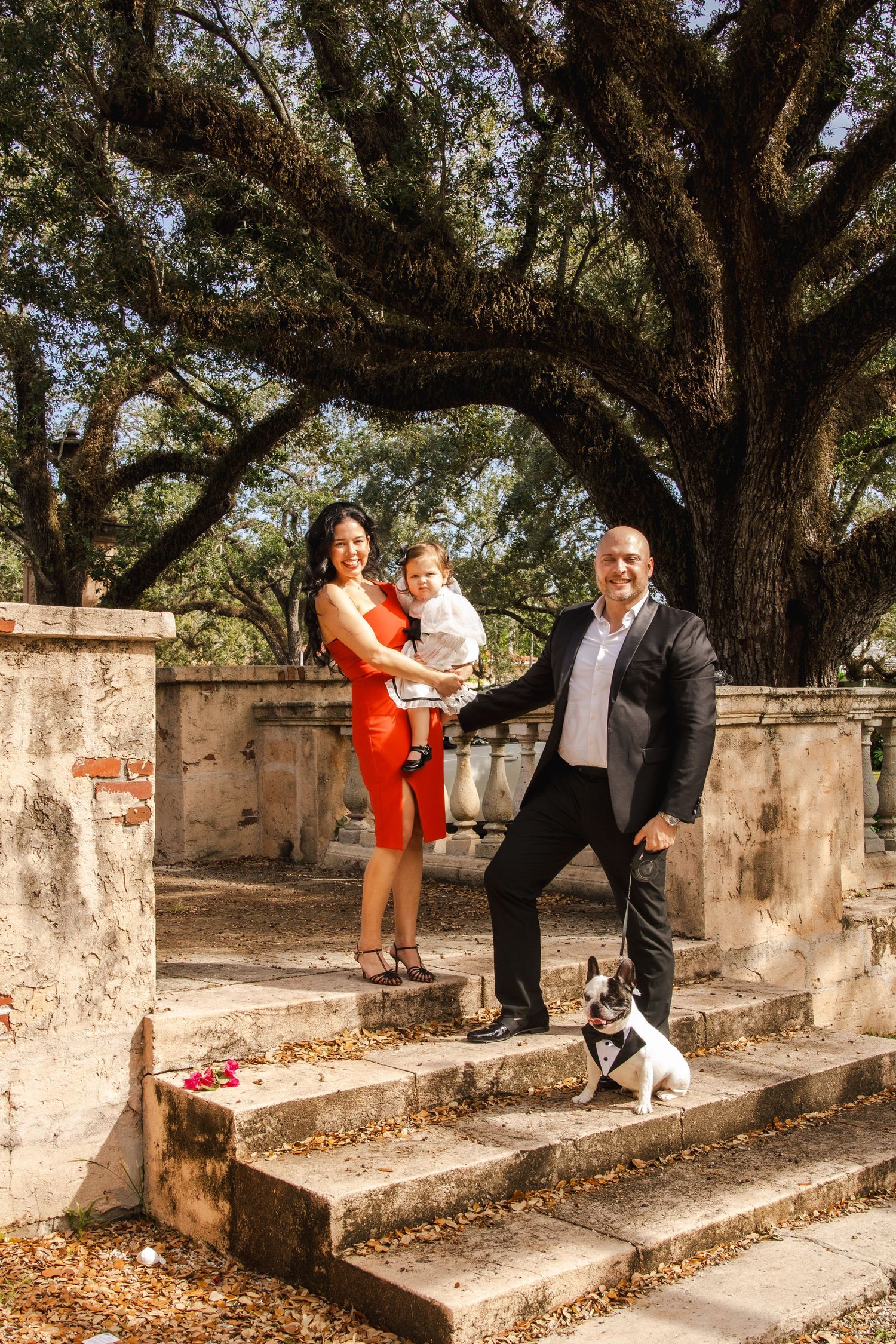A romantic sequence of photos showing a couple in formal attire dancing and embracing on stone steps under oak trees.
