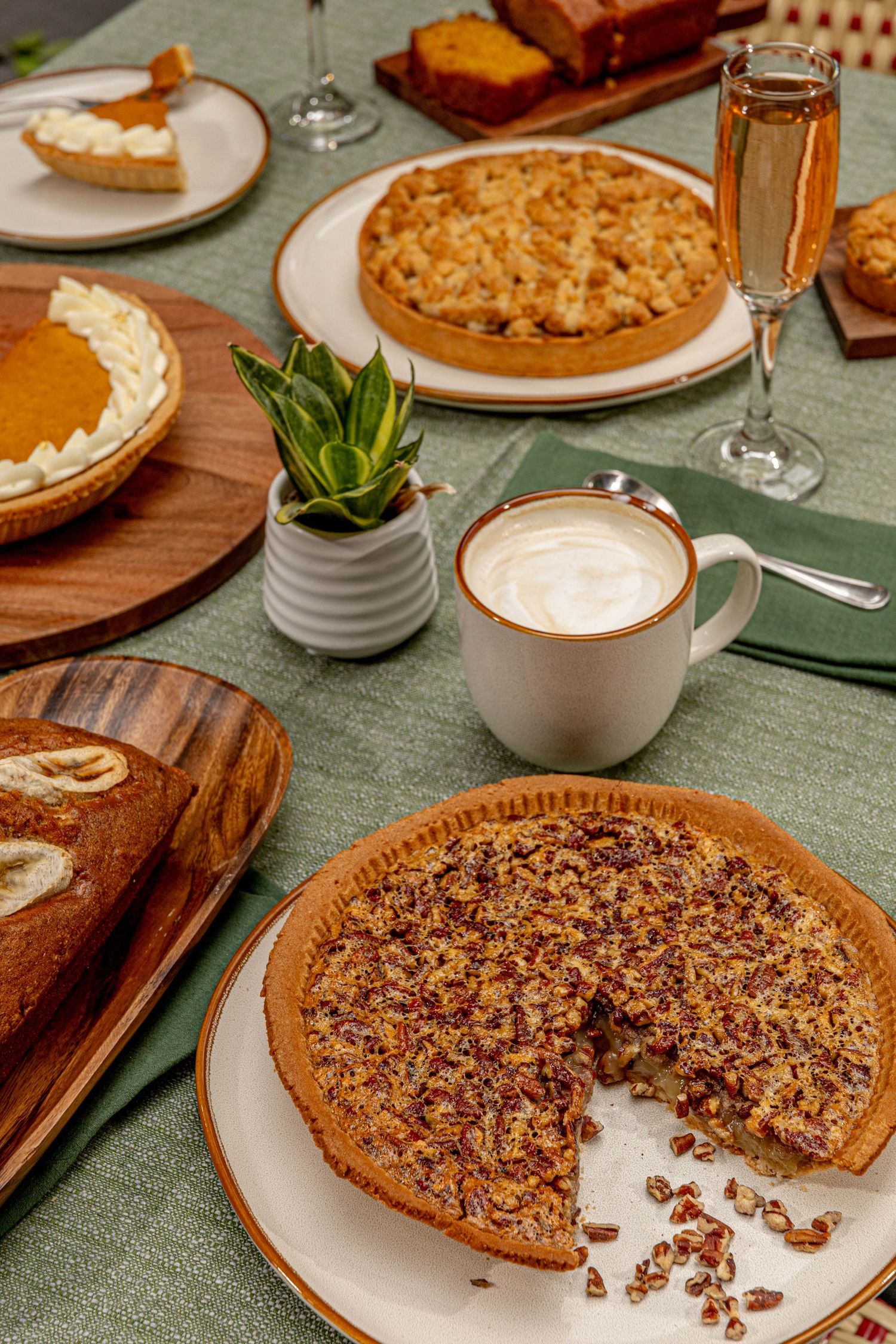 Close-up sequence of a pecan pie being eaten slice by slice on a rustic wooden table setting.