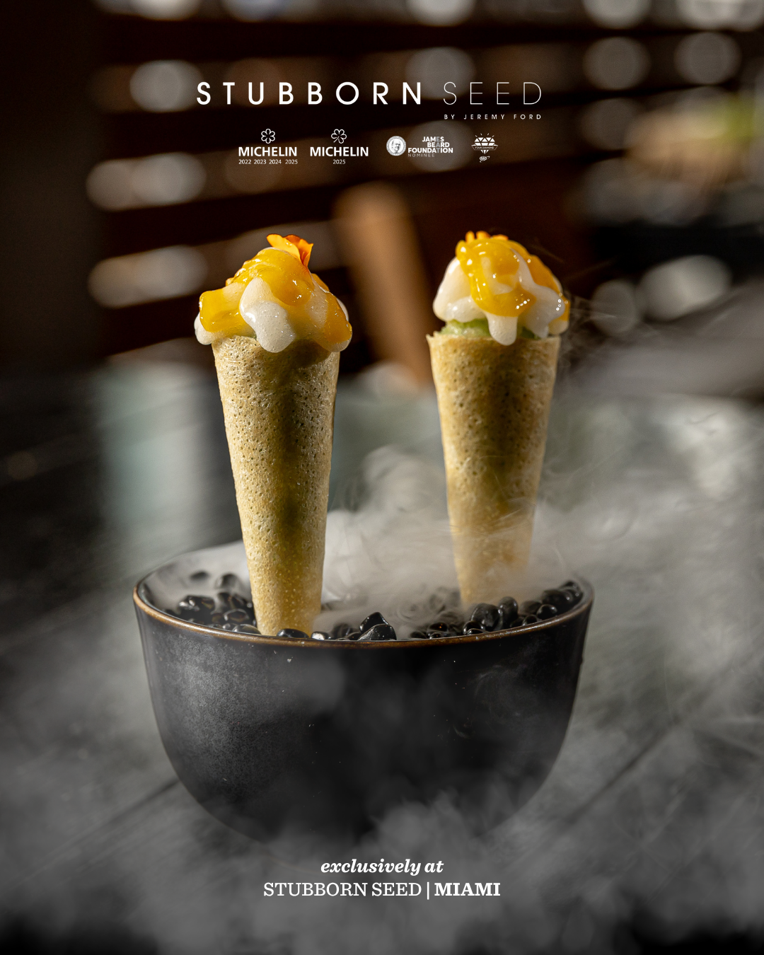 Small ice cream cones displayed in black stones with mango topping at Stubborn Seed Miami.