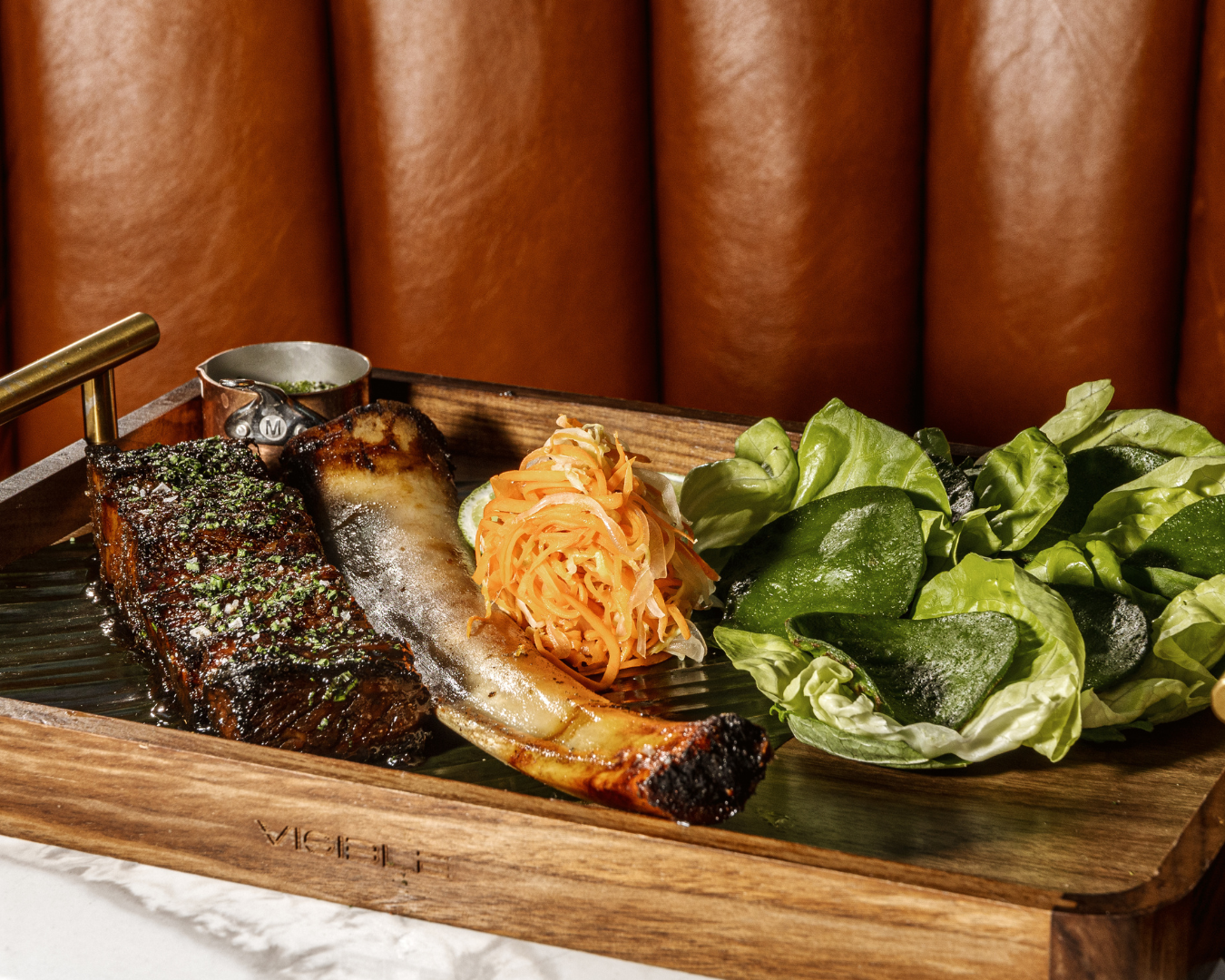 Elegantly plated seafood dish served on a wooden board with fresh greens.