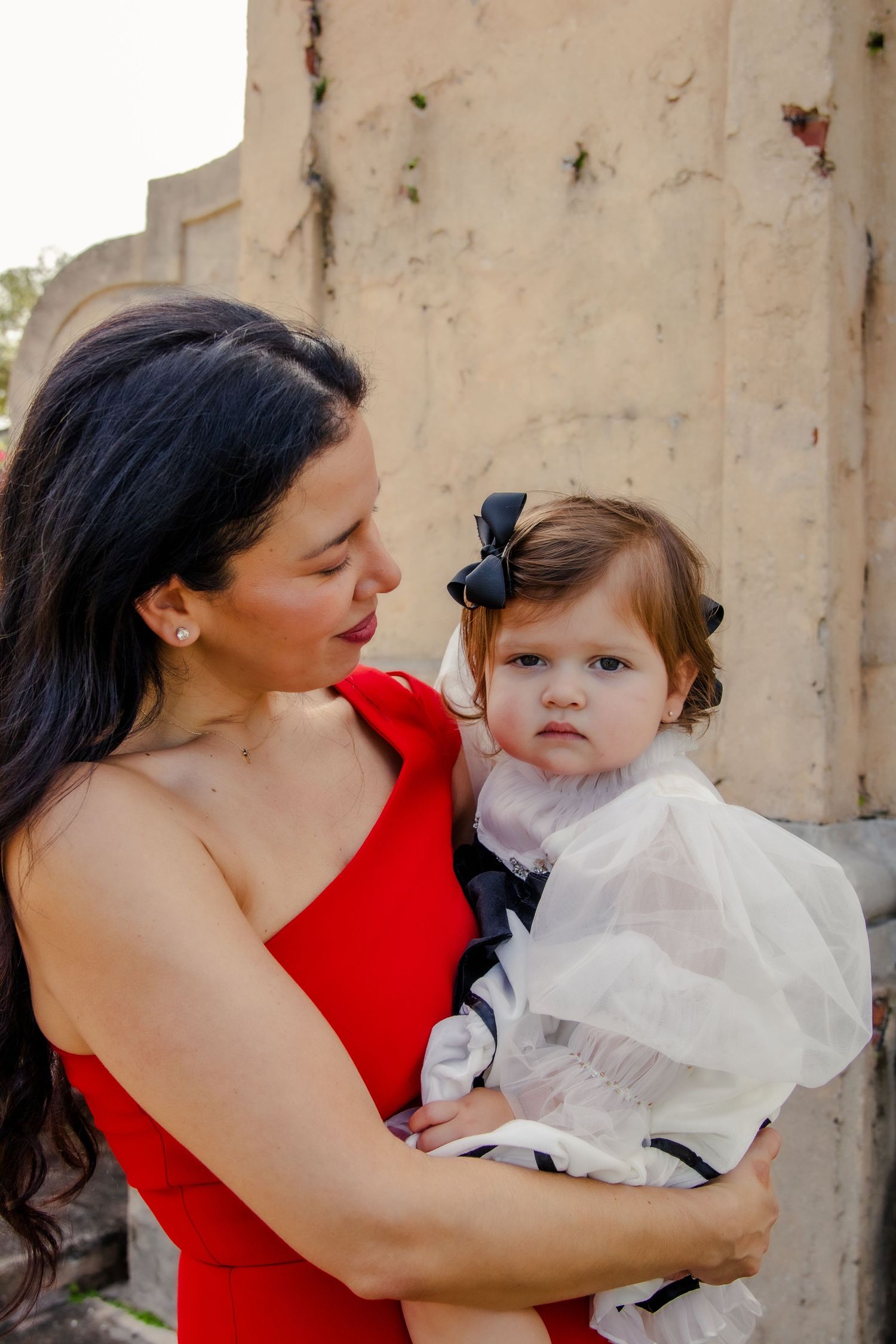 A tender moment captured in a series of photos showing affectionate interaction between two people in red and white attire.