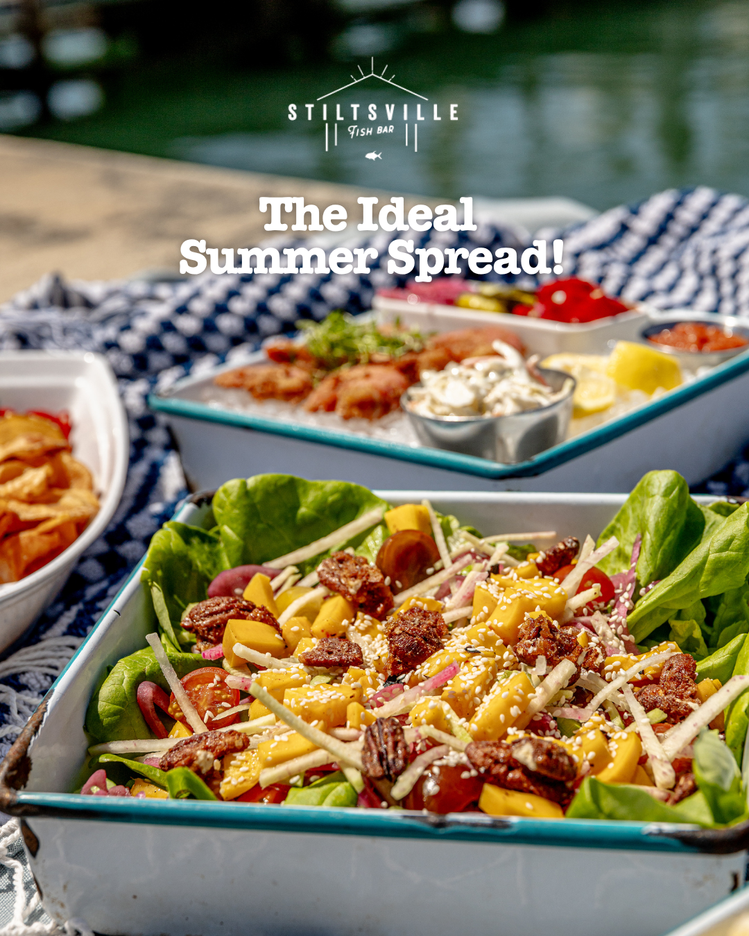 Summer salad spread with cheese, vegetables and toppings in turquoise serving dishes.
