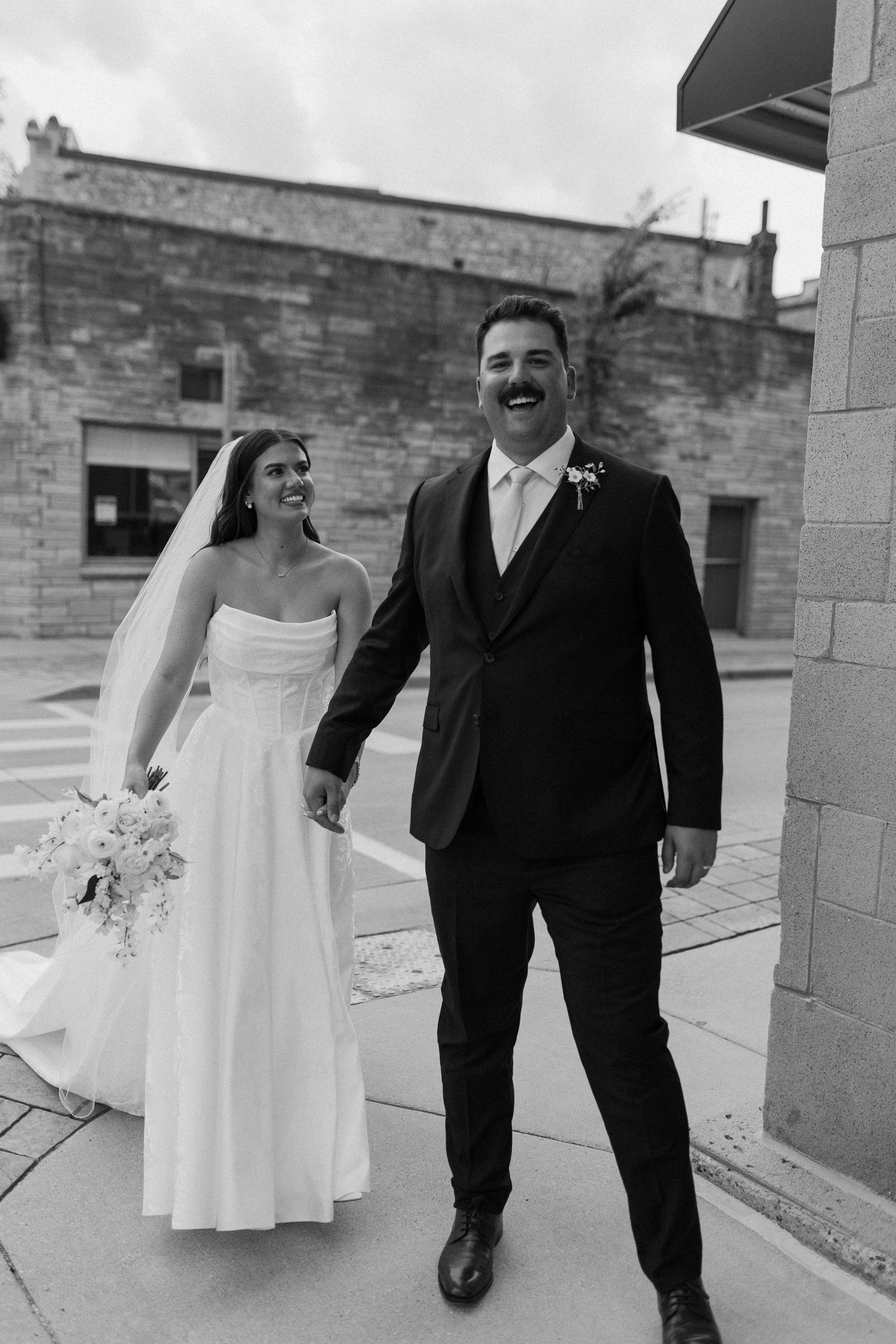 Bride and groom walking together in downtown Waukesha wedding portraits