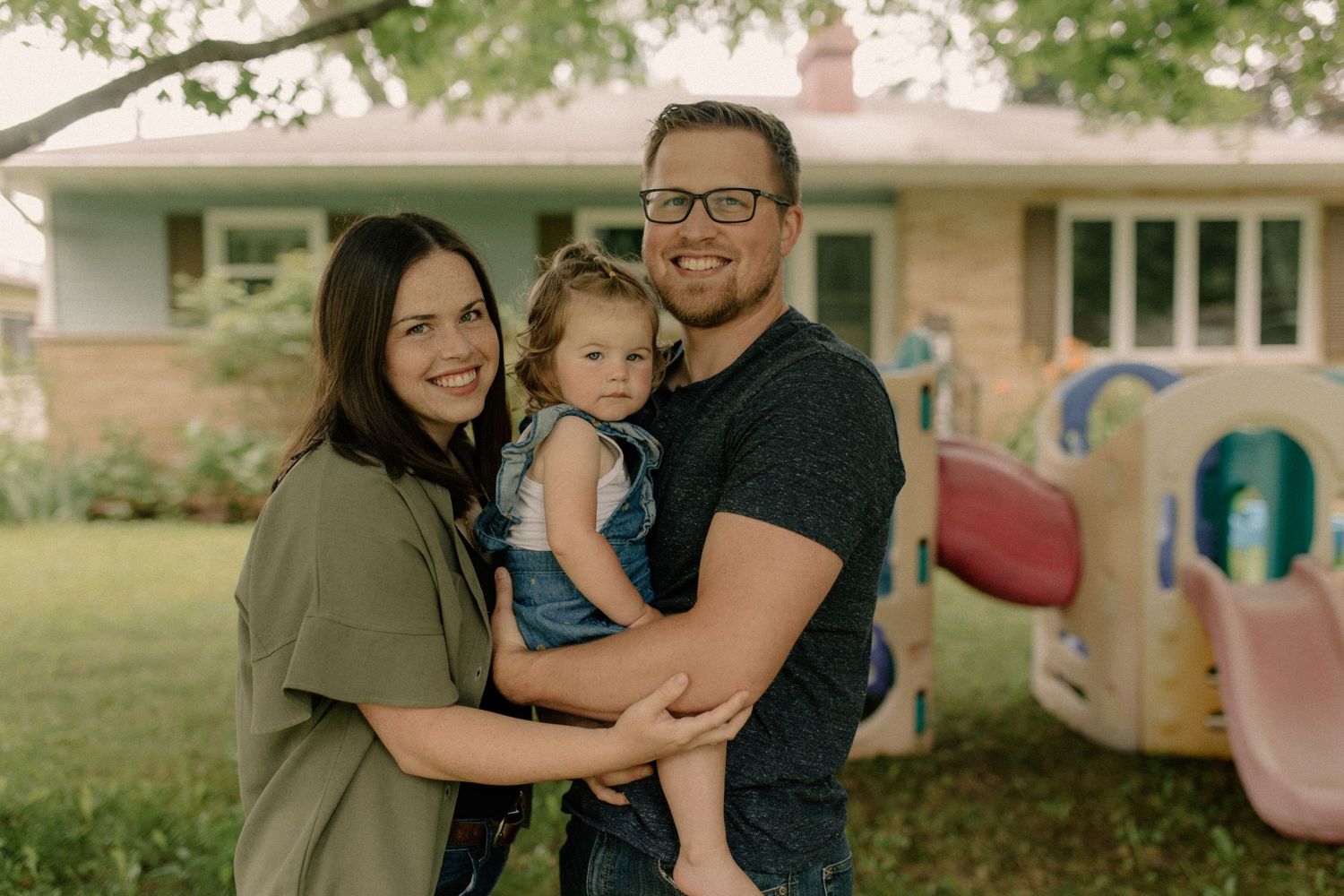 A happy family shares tender moments together in a casual outdoor setting for family photos
