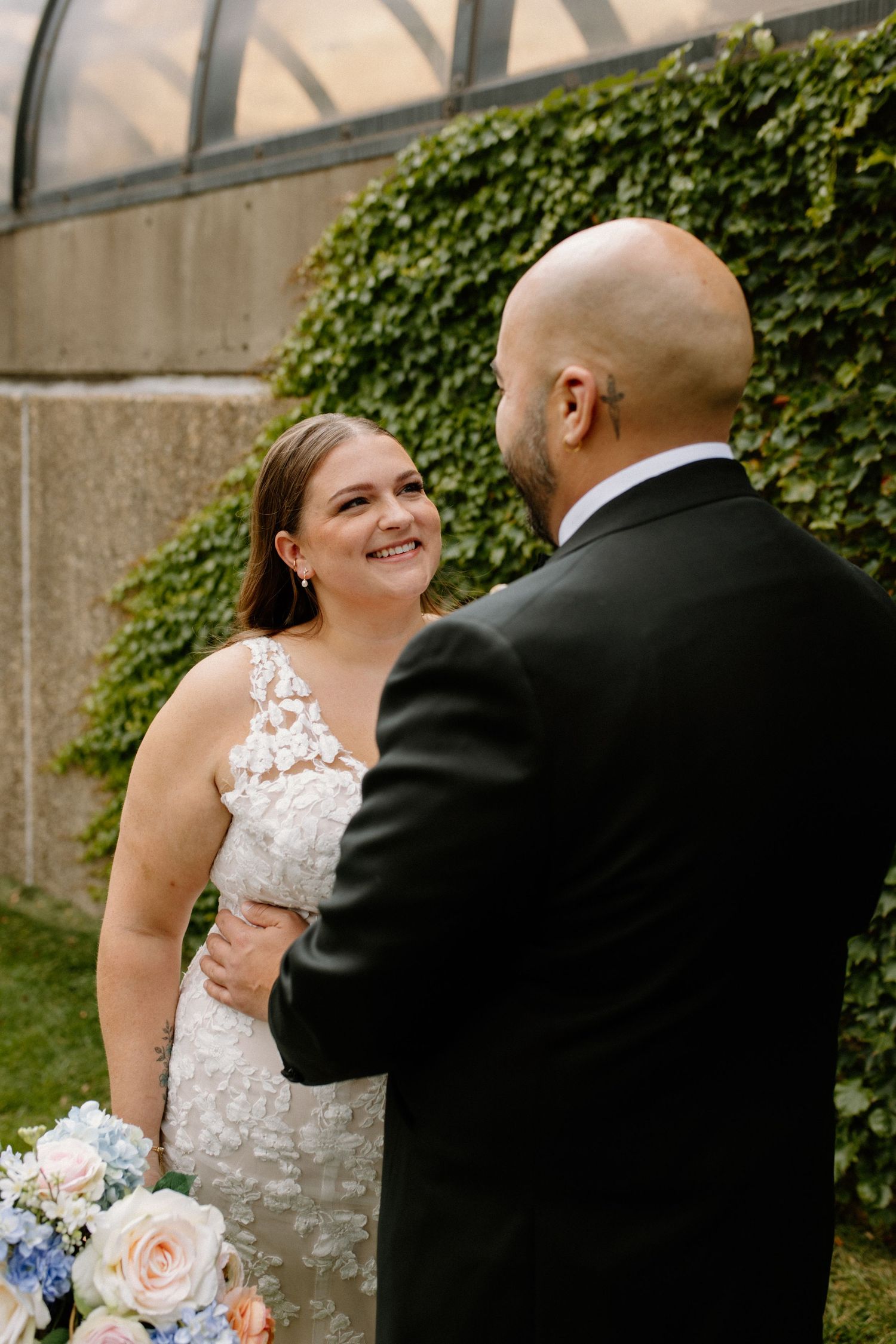 Couple sharing joyful moments during first look at The Grand 1858 Minneapolis Event Center wedding